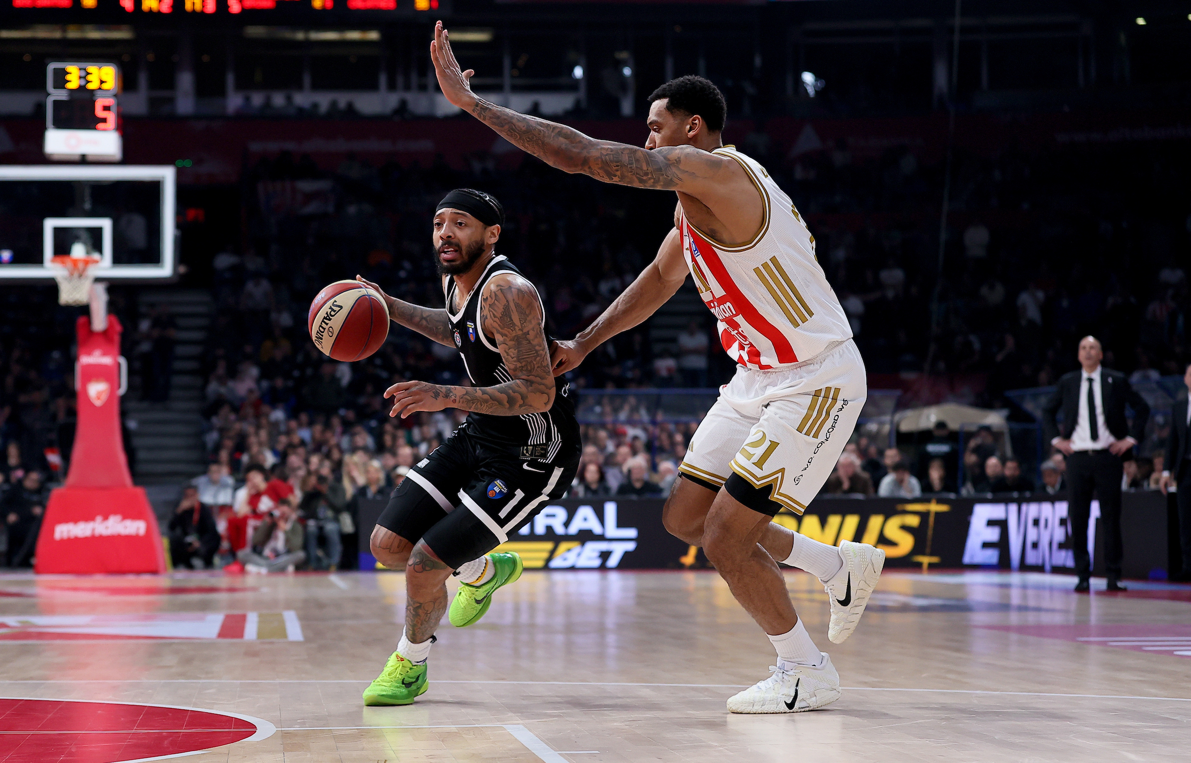 Carlik Jones of Partizan (L) in action against Joel Bolomboy of