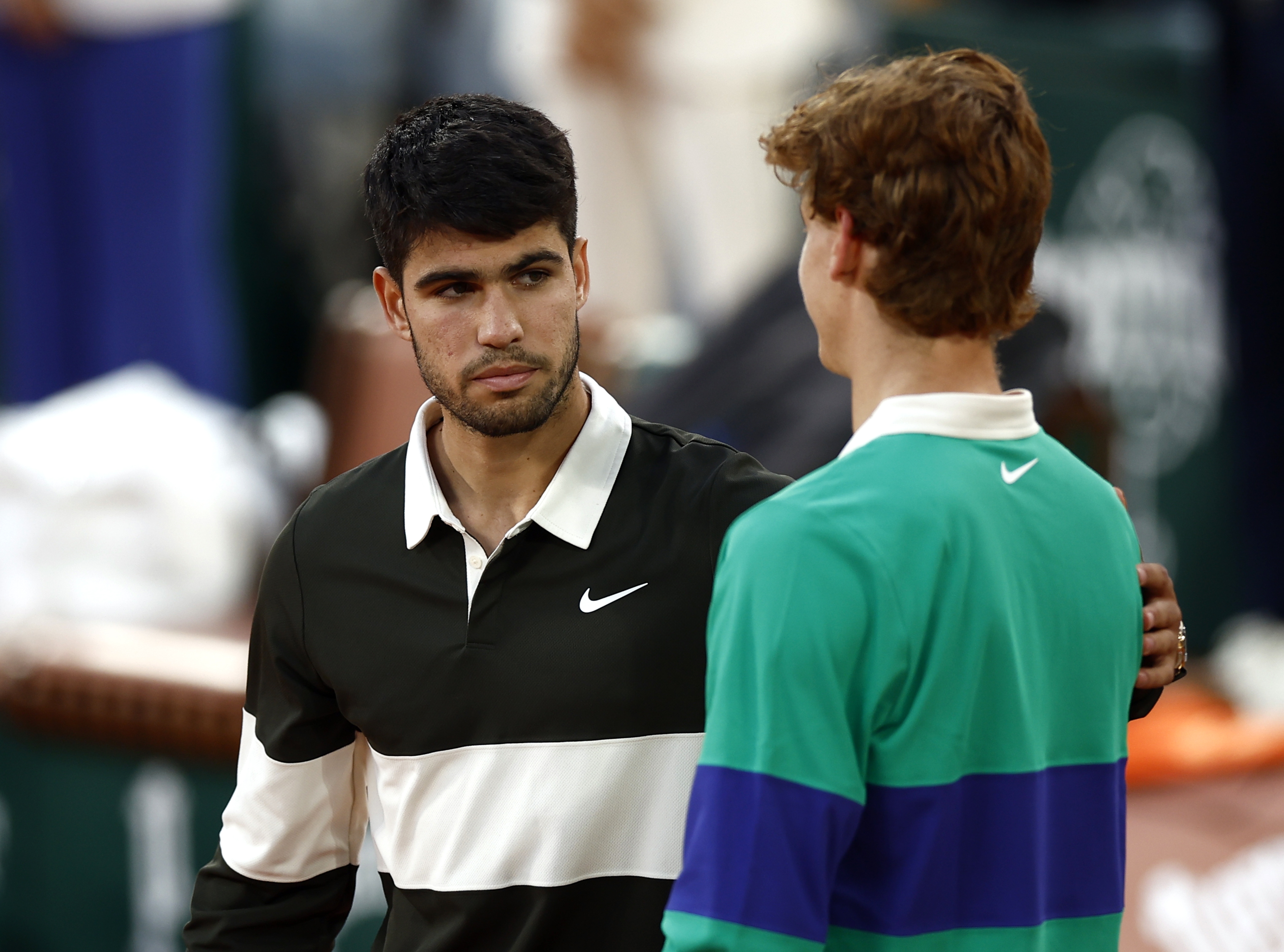 epa12164786 Carlos Alcaraz of Spain (L) reacts with Jannik Sinner