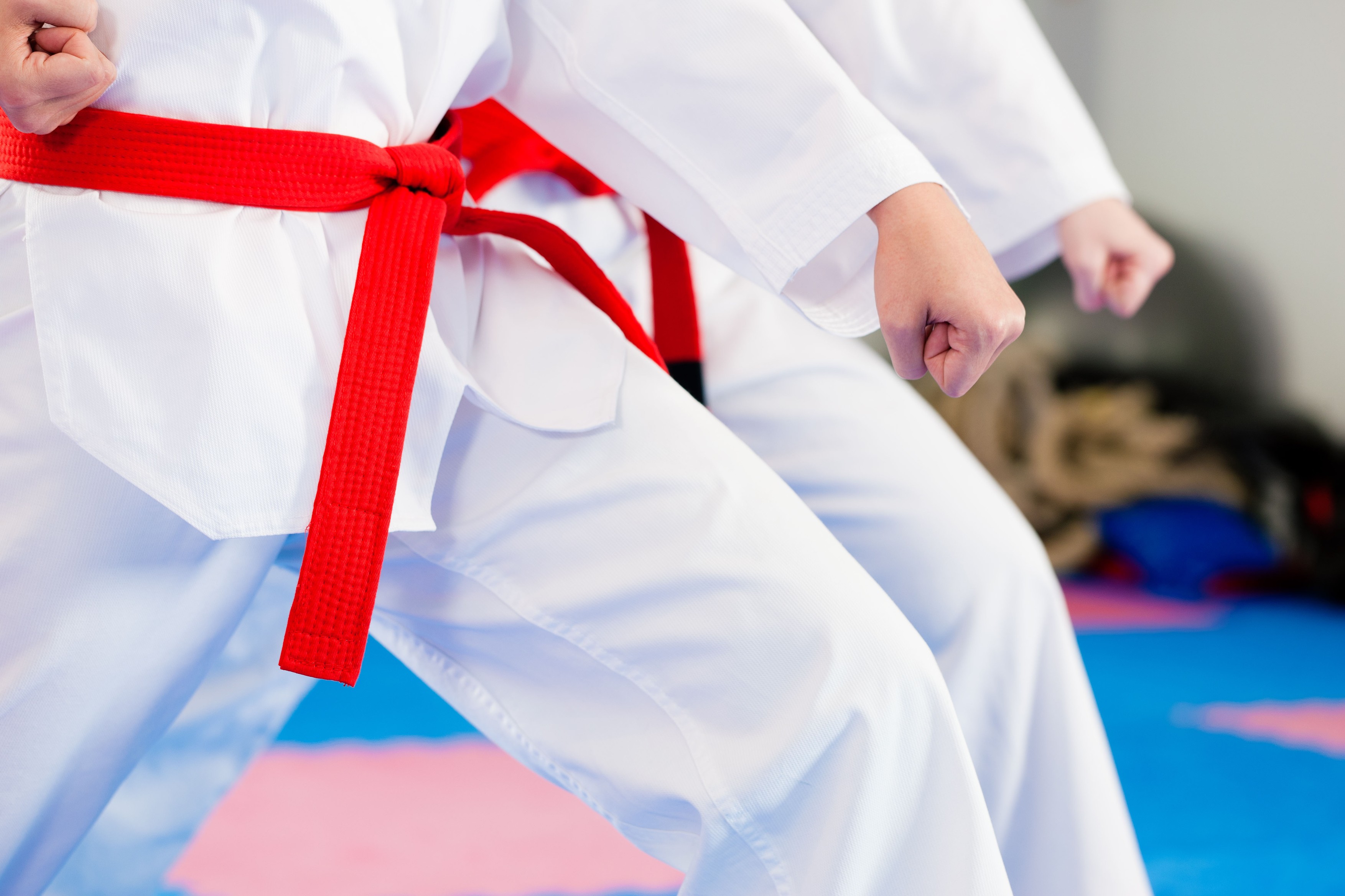 People in a gym in martial arts training exercising Taekwondo