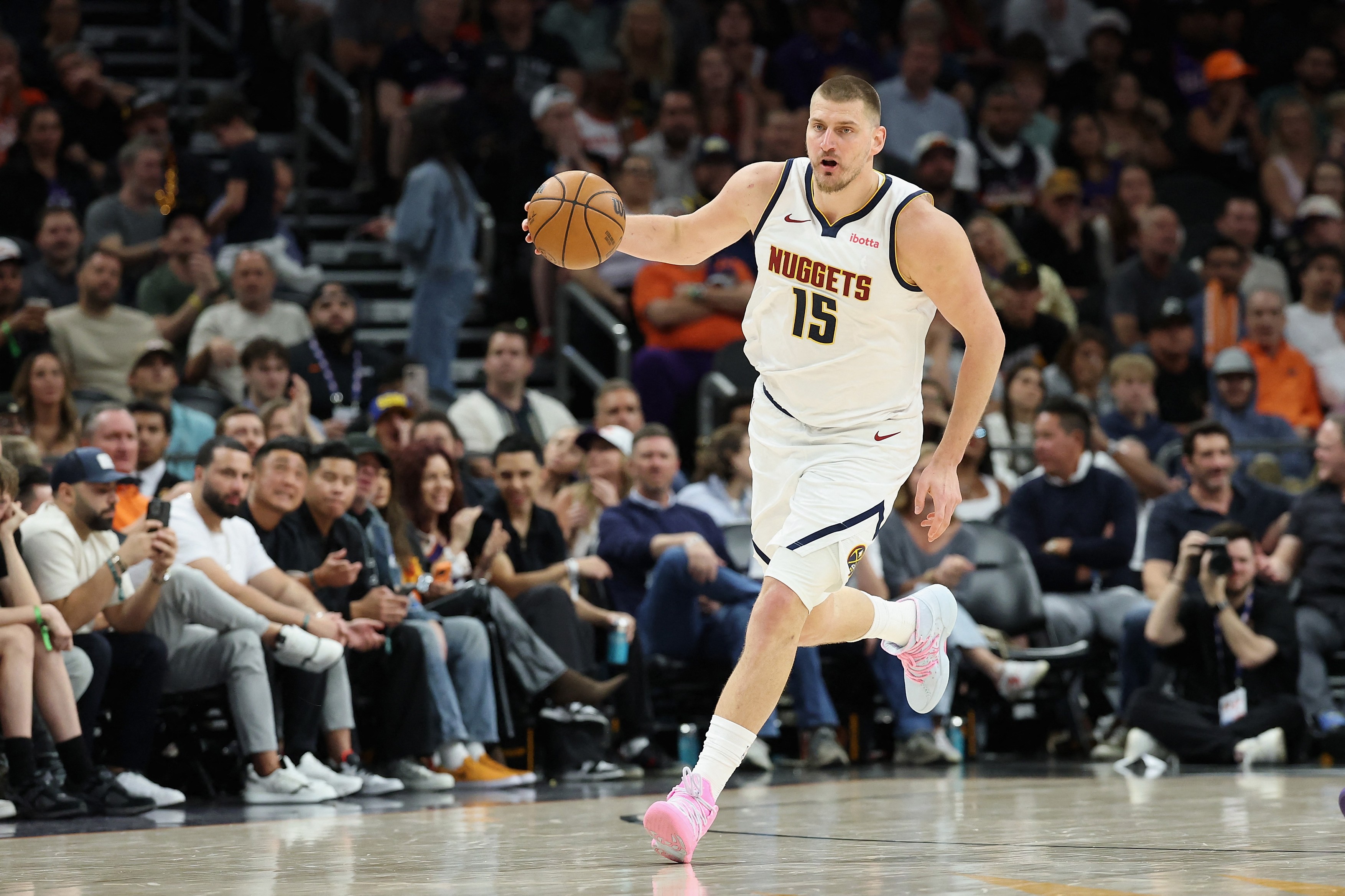 Nikola Jokic #15 of the Denver Nuggets handles the ball