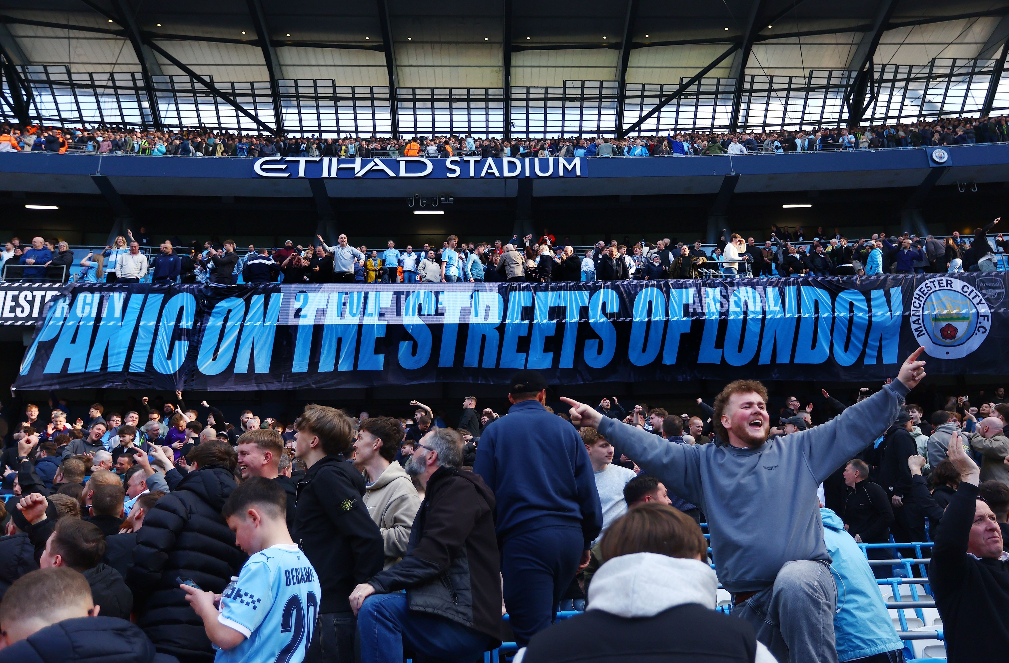 Manchester City fans display a panic on the streets of London banner