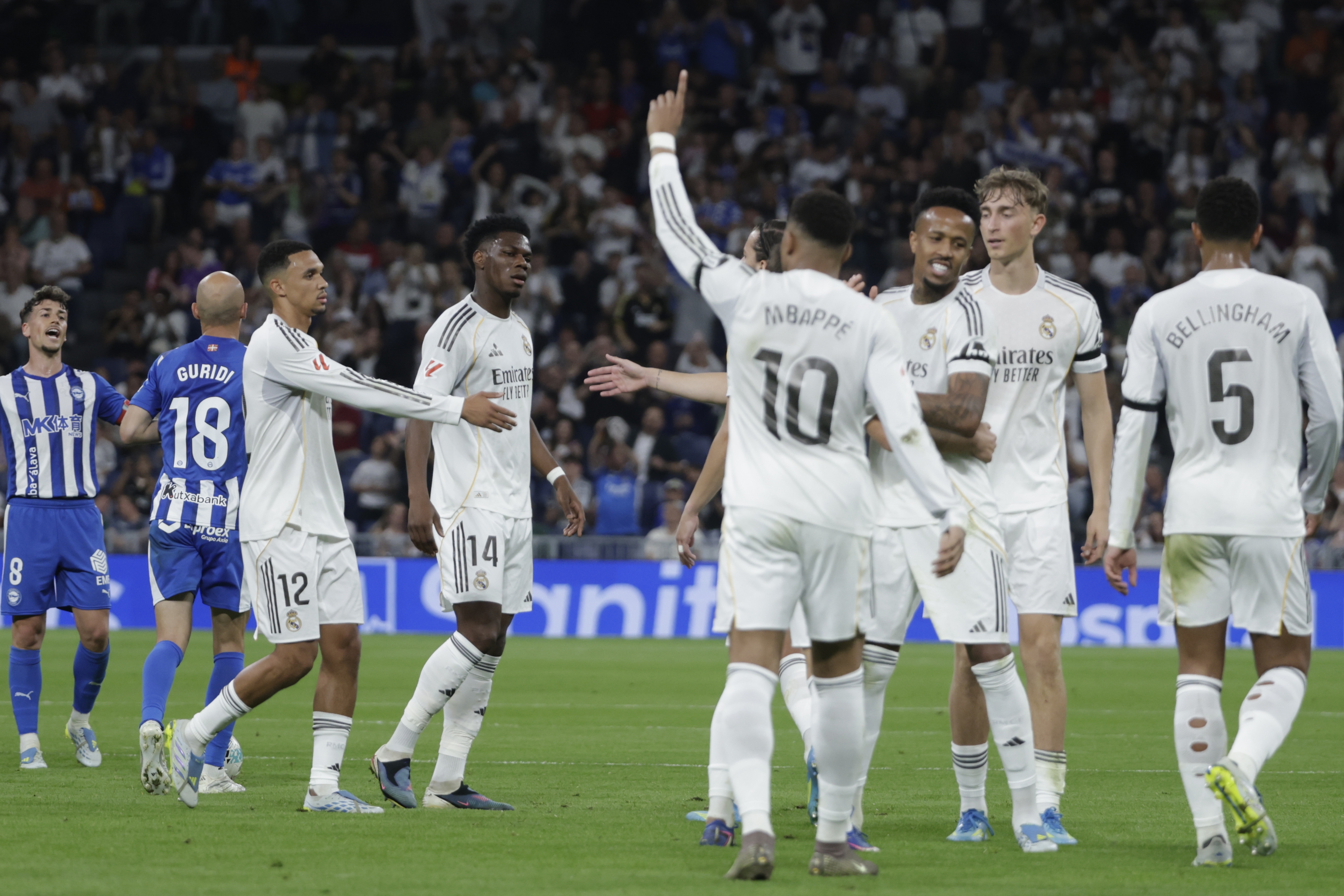 Real Madrid's Kylian Mbappe (C) celebrates after scoring the 1-0 goal during the Spanish LaLiga soccer match between Real Madrid and Deportivo Alaves at the Santiago Bernabeu Stadium