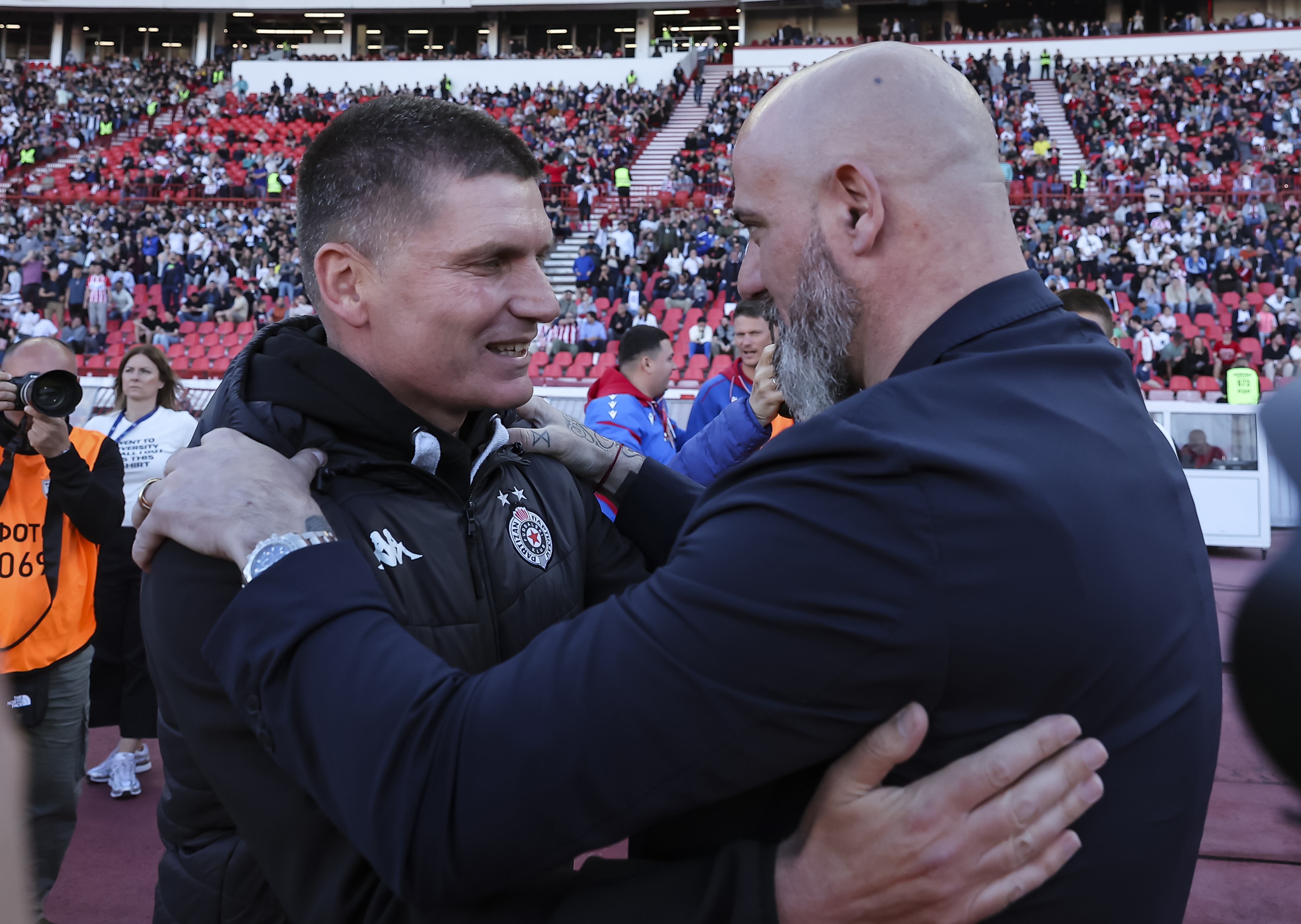 Head coach Srdjan Blagojevic (L) of Partizan shake hands with Head coach Dejan Stankovic