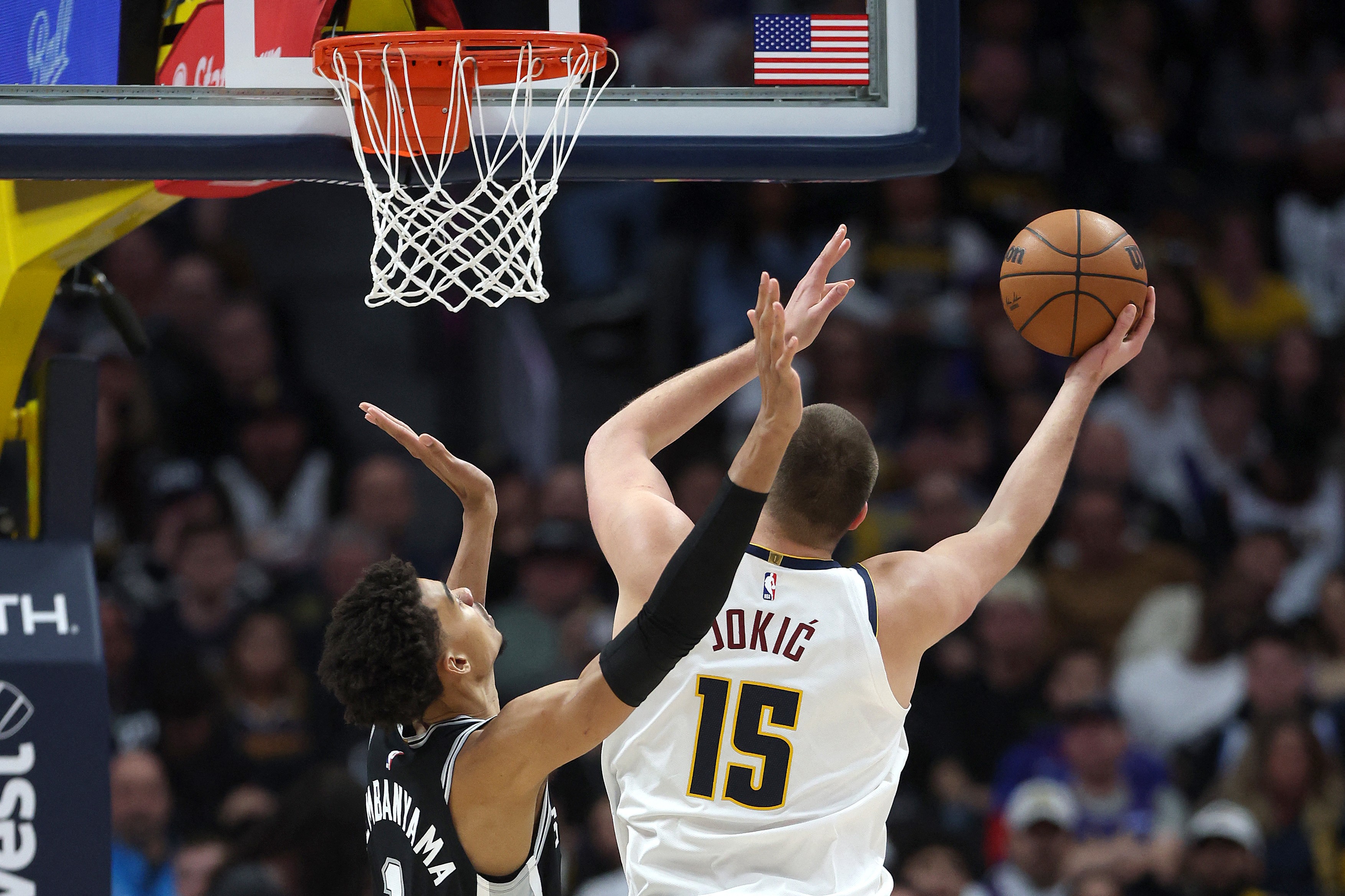 DENVER, COLORADO - JANUARY 03: Nikola Jokic #15 of the Denver Nuggets puts up a shot against Victor Wembanyama #1 of the San Antonio Spurs