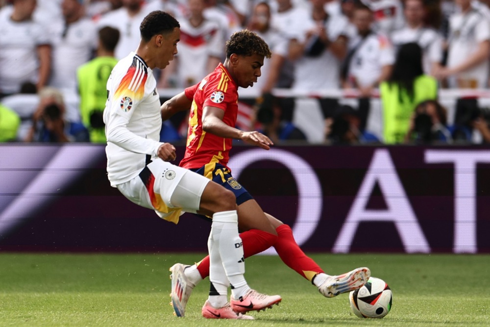 epa11459758 Jamal Musiala of Germany (L) in action against Lamine Yamal of Spain during the UEFA EURO 2024 quarter-finals soccer match between Spain and Germany, in Stuttgart, Germany, 05 July 2024.  EPA/ANNA SZILAGYI