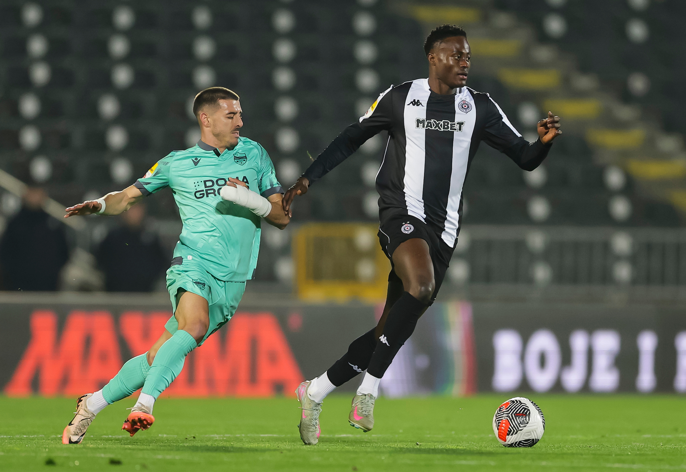 Demba Seck (R) of Partizan in action against Ivan Davidovic (L) of Novi Pazar