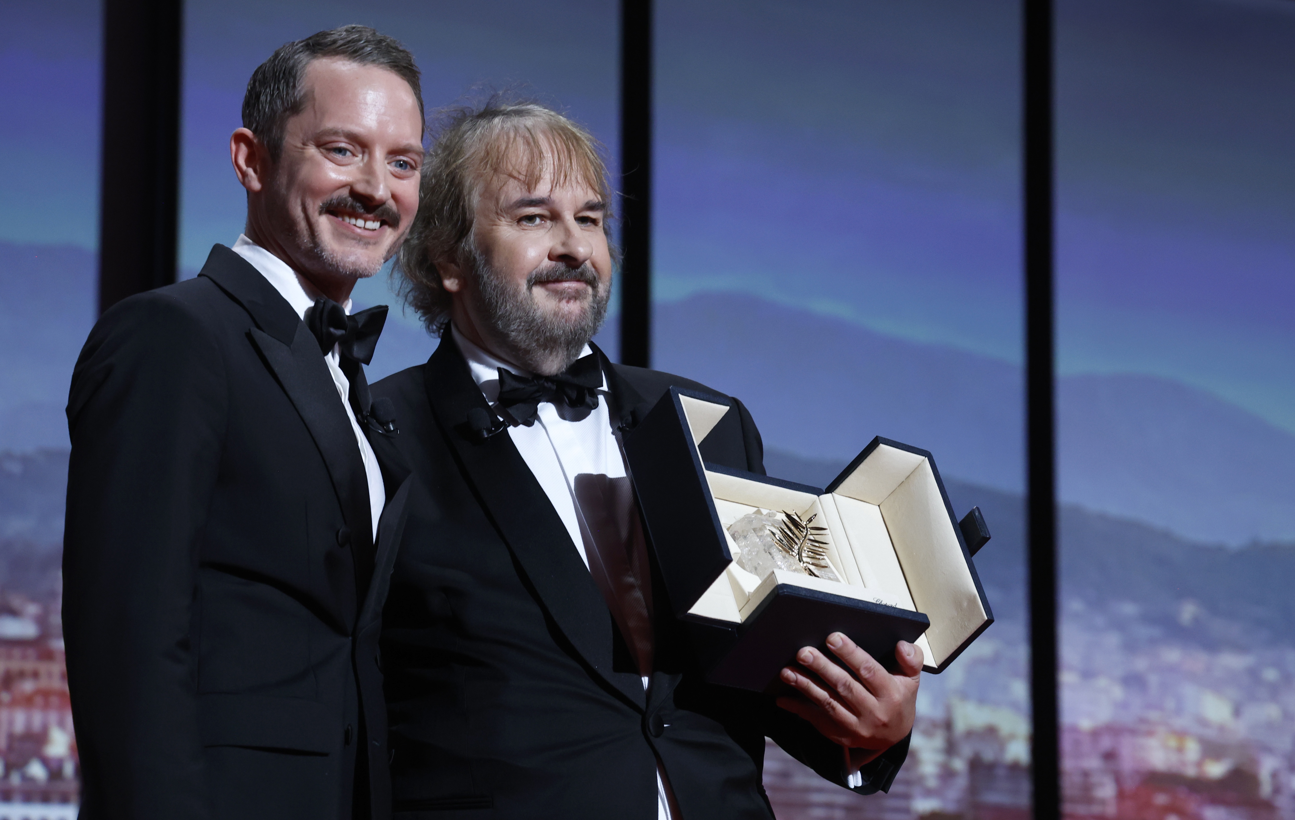epa12951054 Peter Jackson (R) receives his Honorary Palme d'Or from Elijah Wood