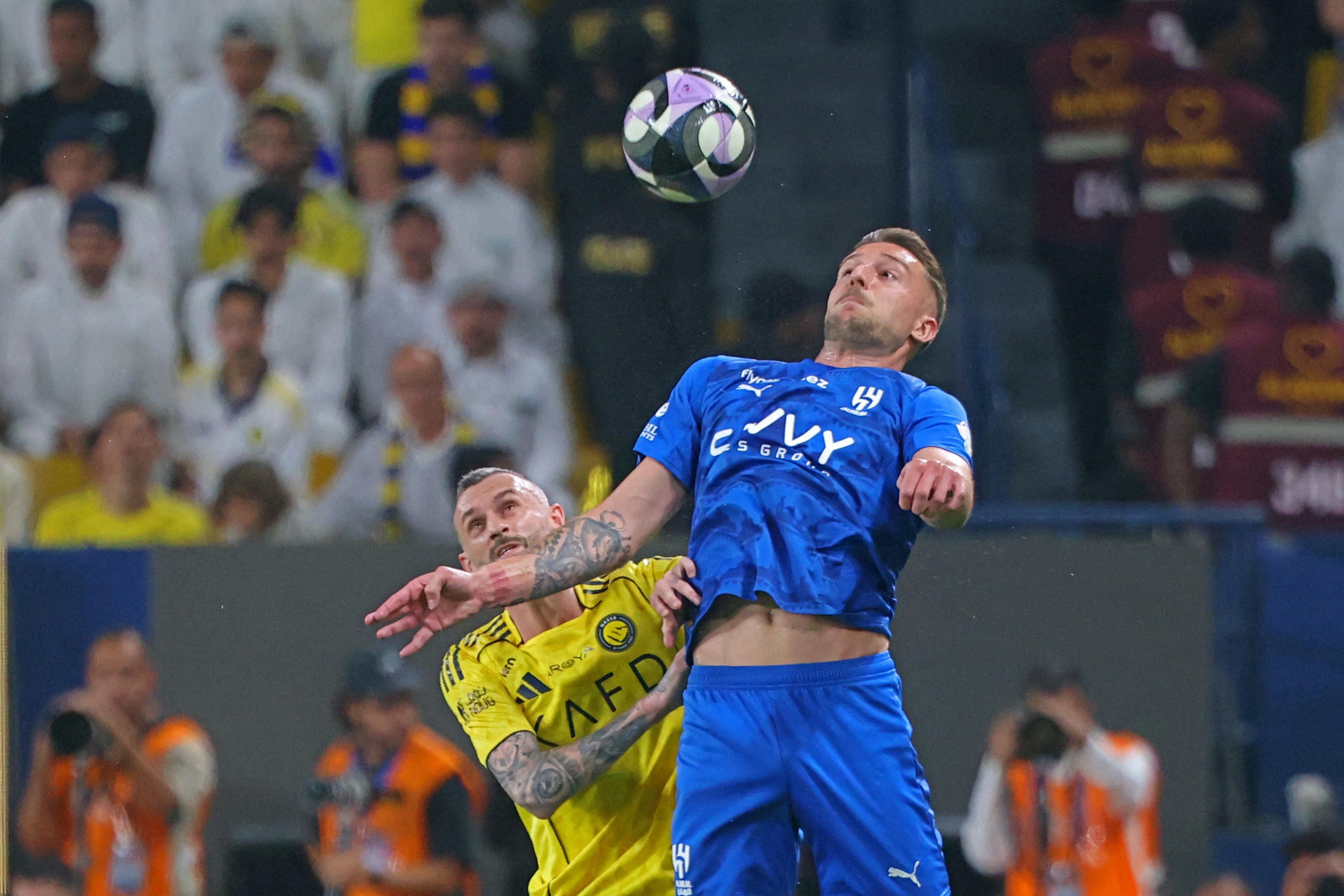 Nassr's Croatian midfielder #11 Marcelo Brozovic (L) fights for the ball with Al-Hilal Serbian midfielder #22 Sergej Milinkovic-Savic during the Saudi Pro League football match
