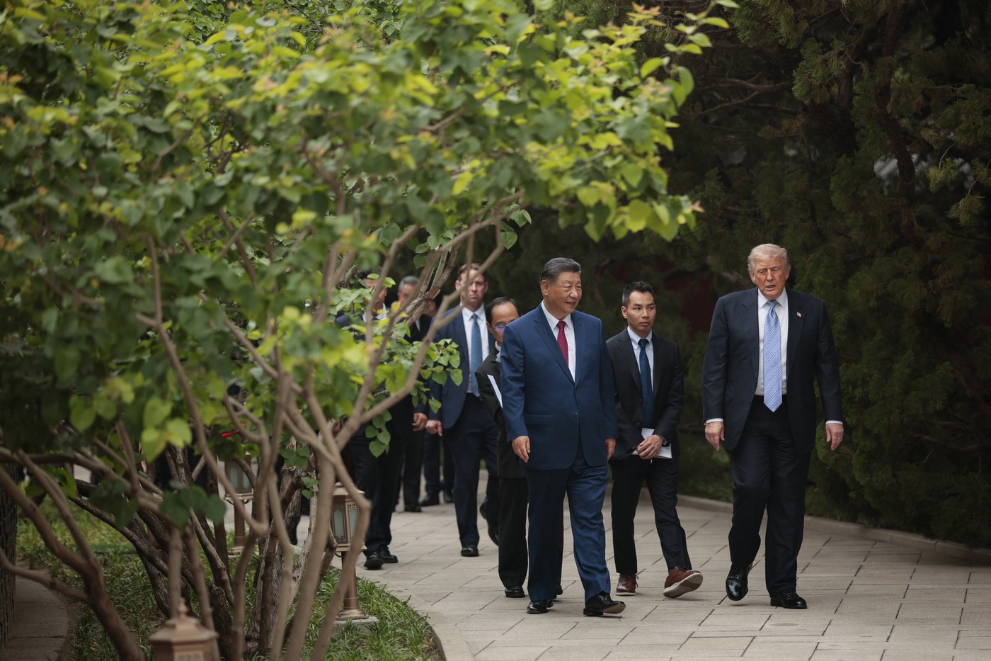 US President Donald Trump (R) walks with China’s President Xi Jinping (C)