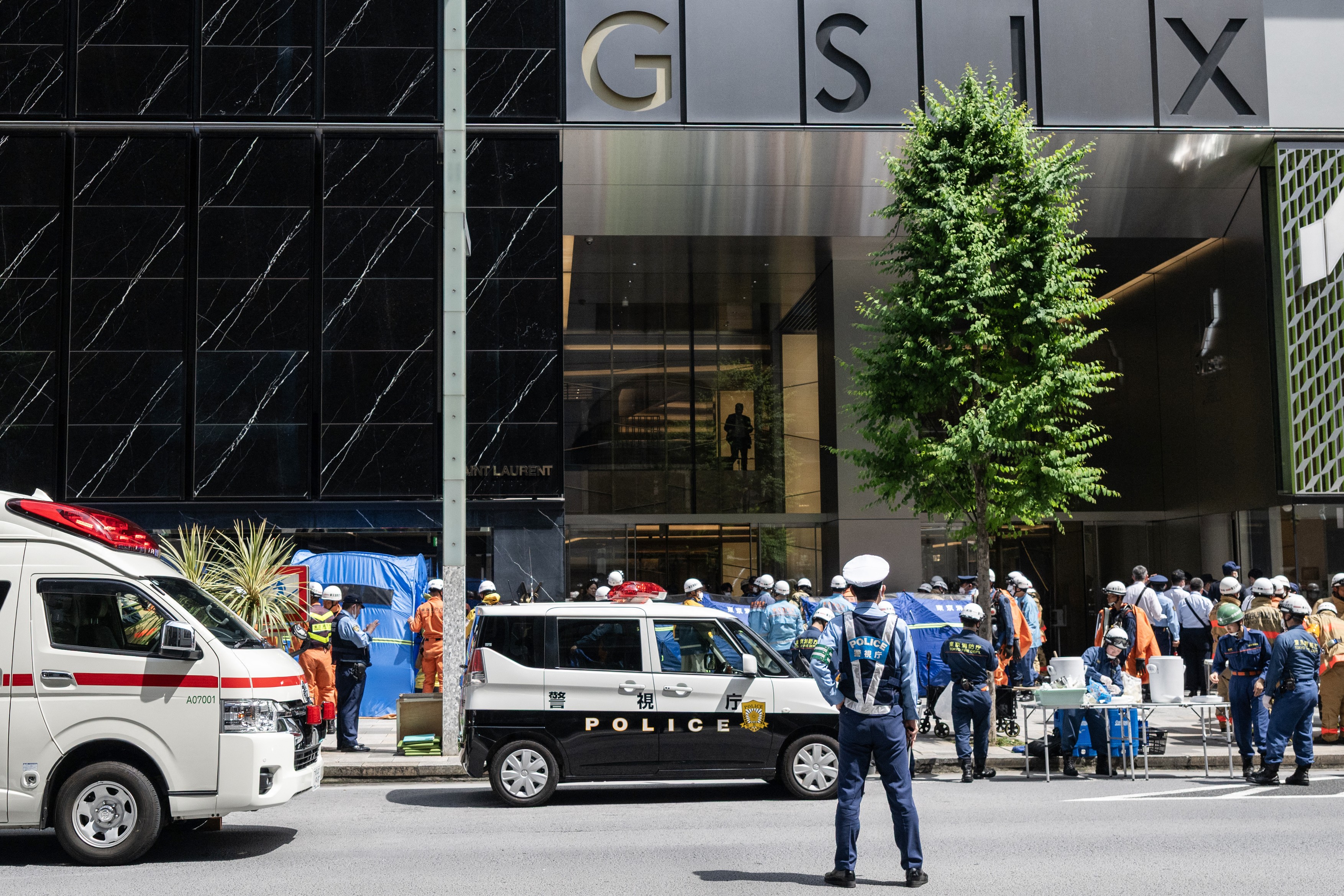 Emergency personnel are seen in front of the Ginza 6 Shopping Center in Tokyo on May