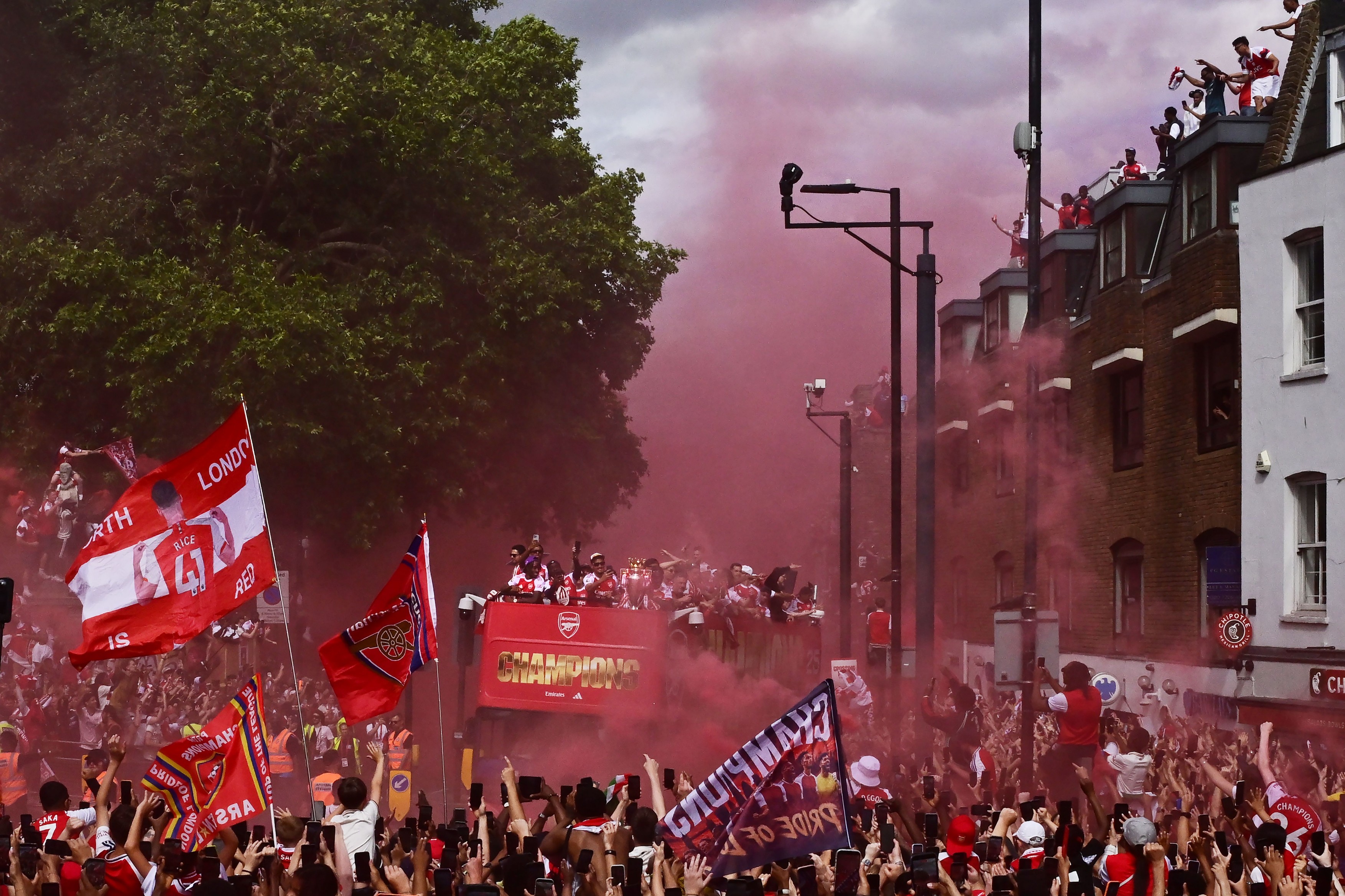 Arsenal fans celebrate as the Premier League champions parade
