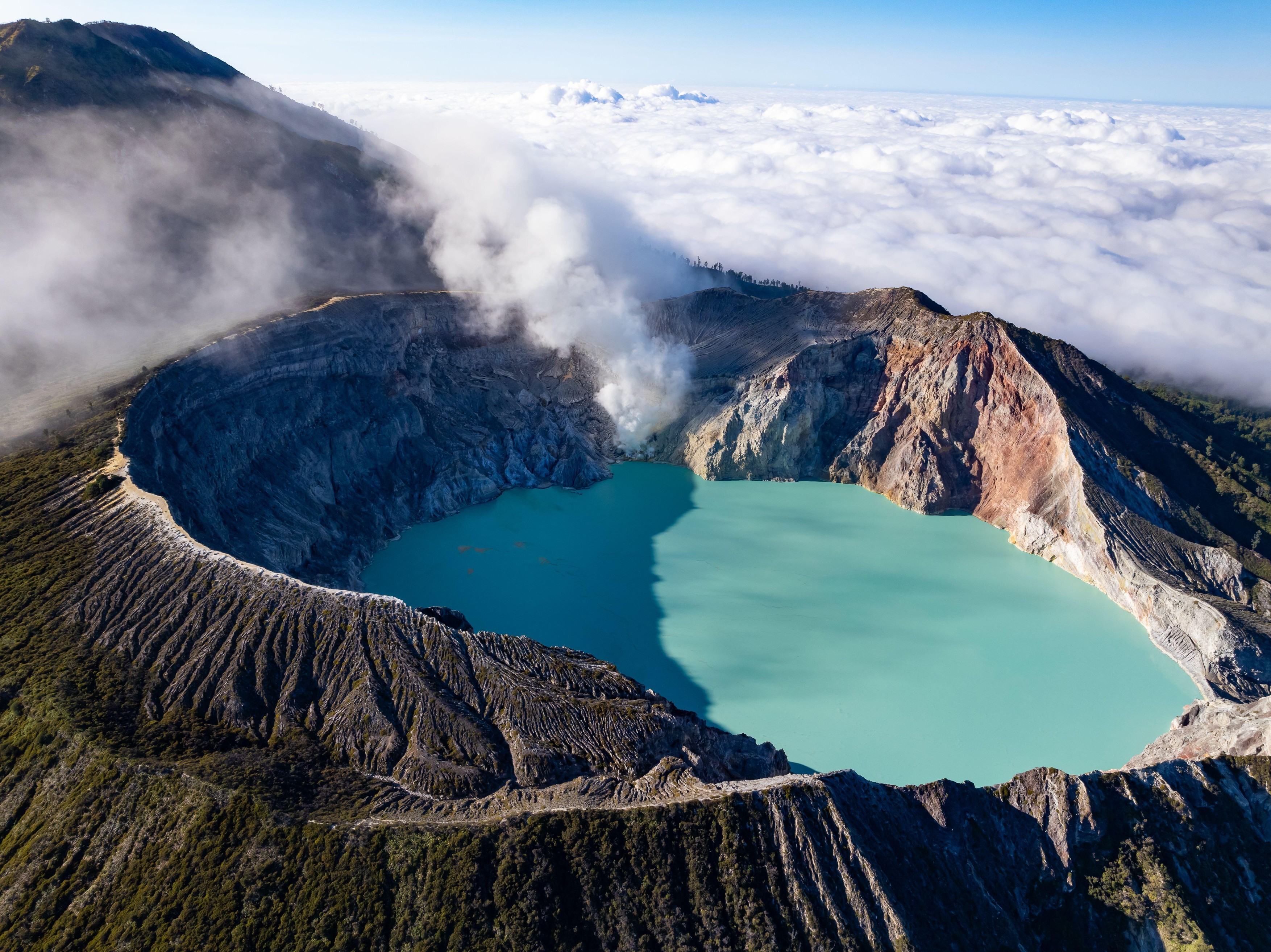 Aerial view Kawah Ijen volcano with turquoise sulfur water lake