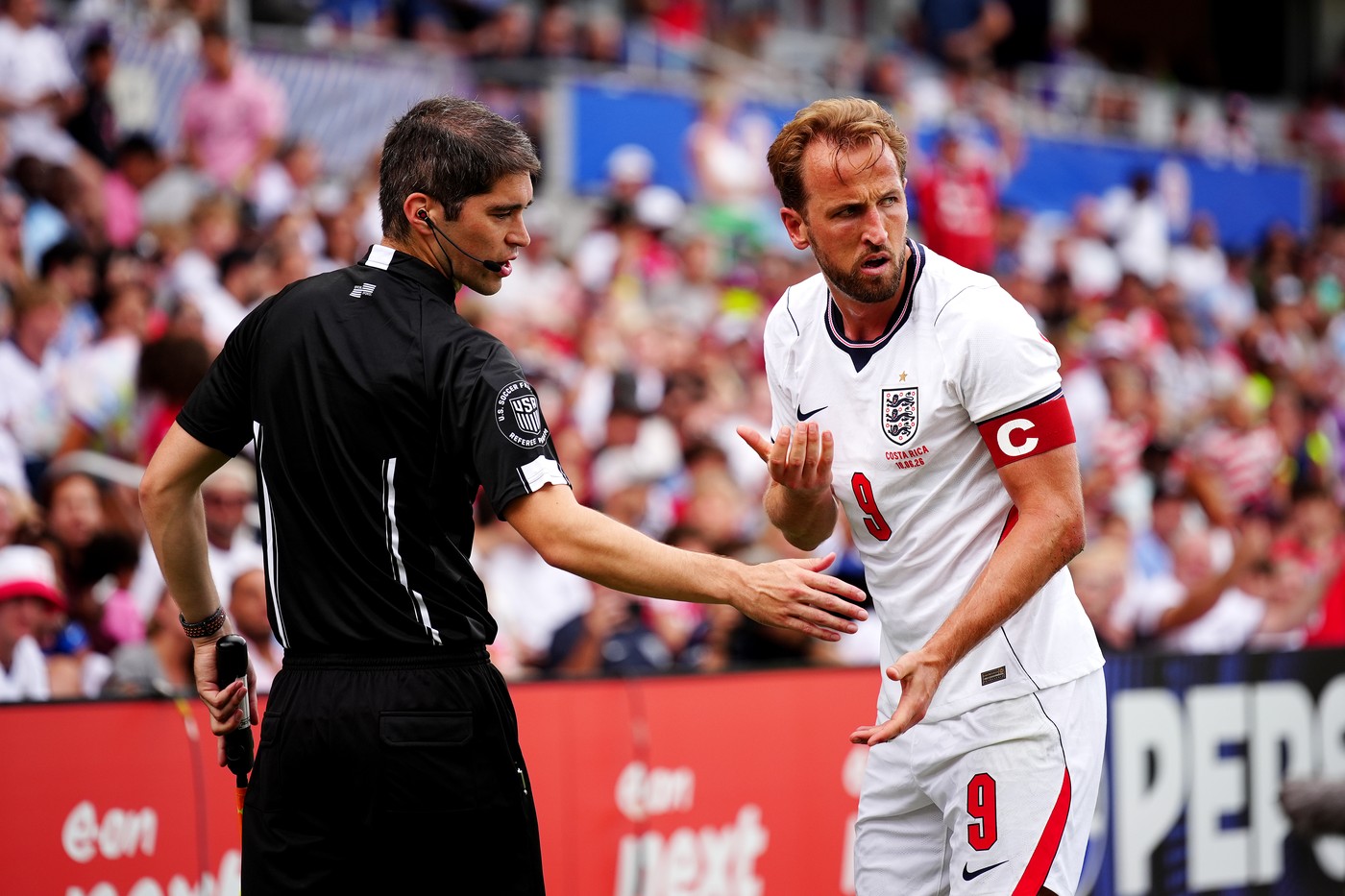 England's Harry Kane (right) and assistant referee Stefan Tanaka-Freundt dur