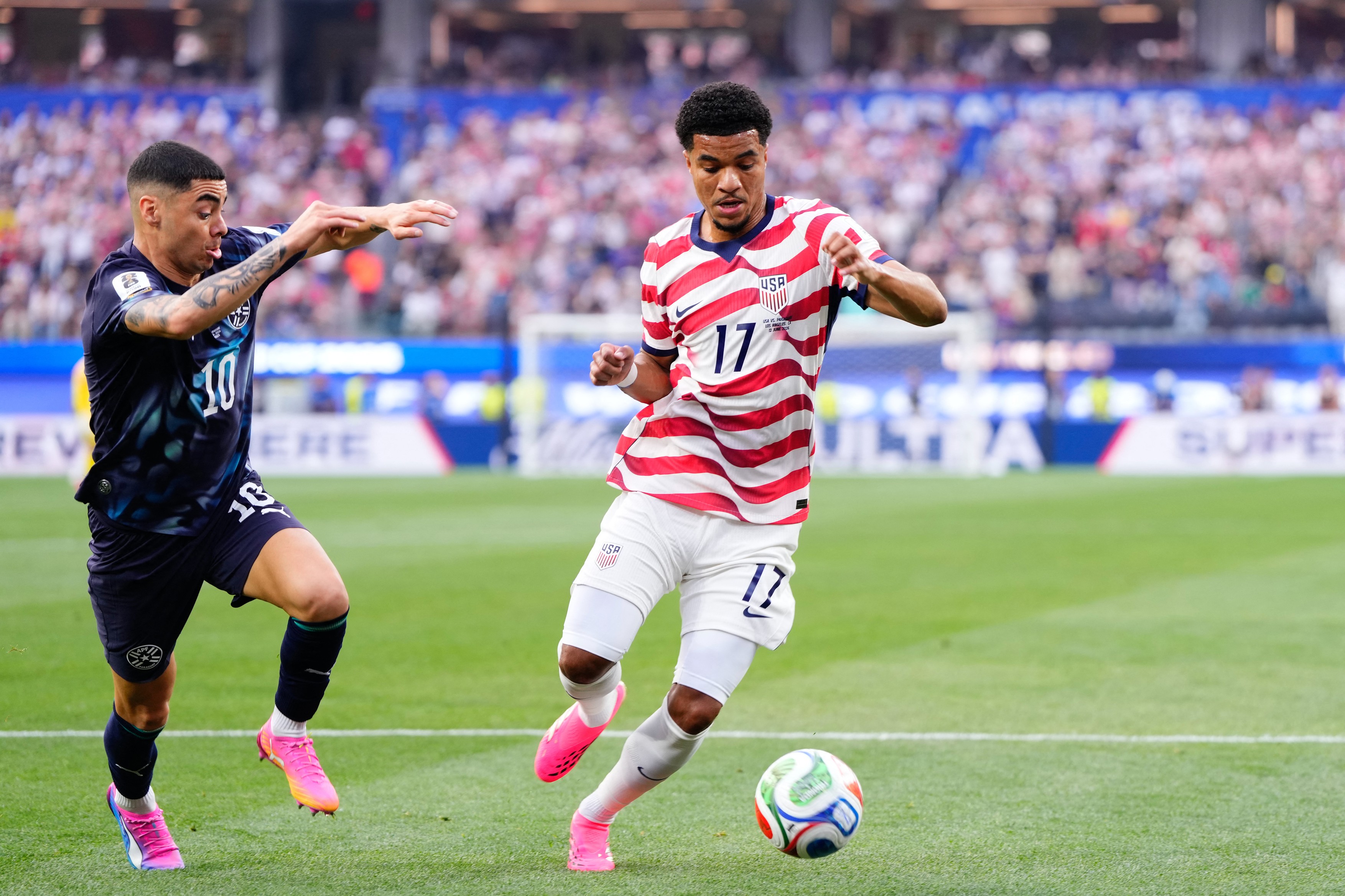 Malik Tillman of USA and Miguel Almiron of Paraguay