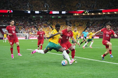 Australia's Mohamed Toure (9) and Turkey's Abdulkerim BardakcÄ± (14) vi