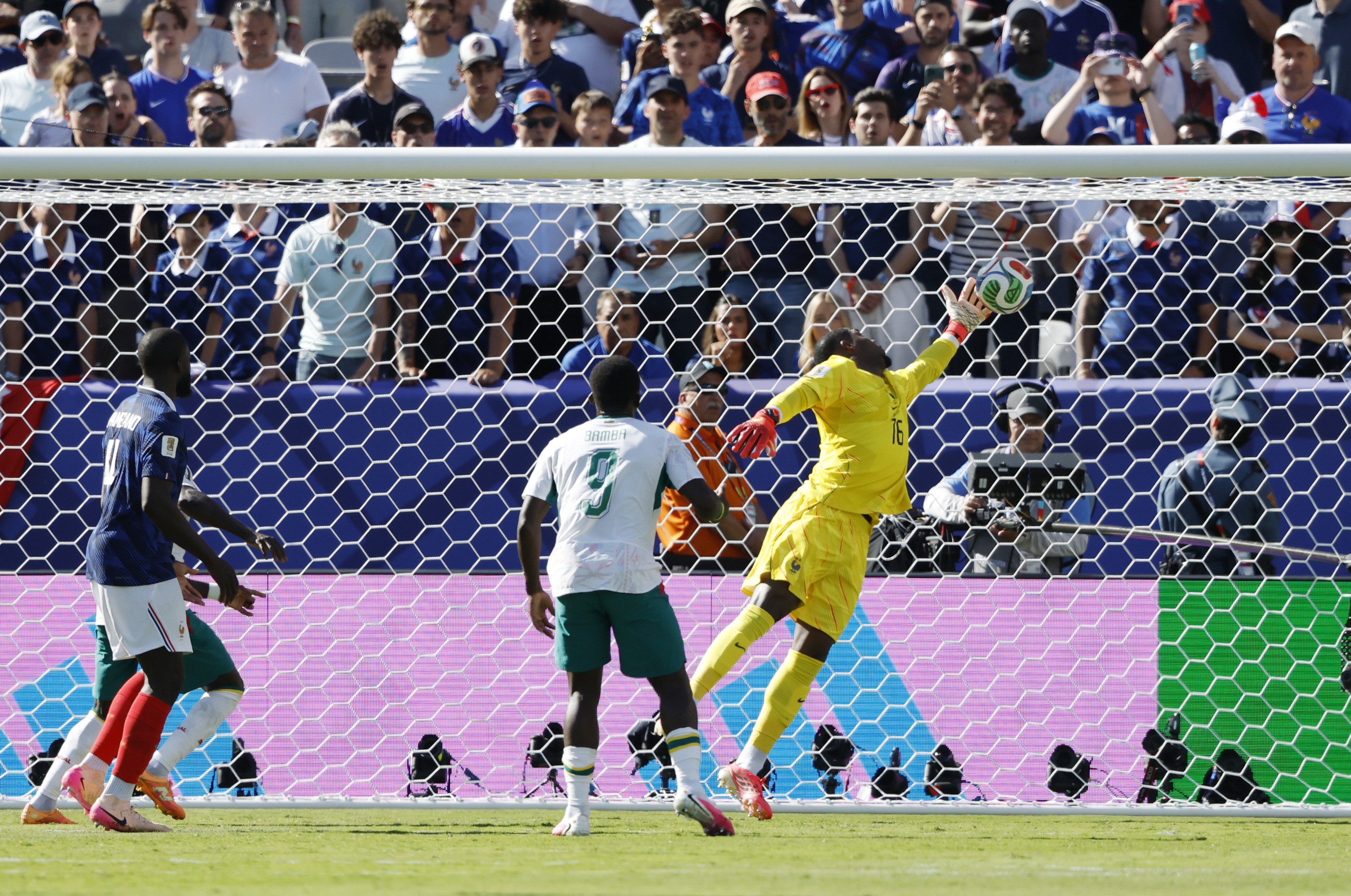 Senegal's Ibrahim Mbaye (hidden) scores