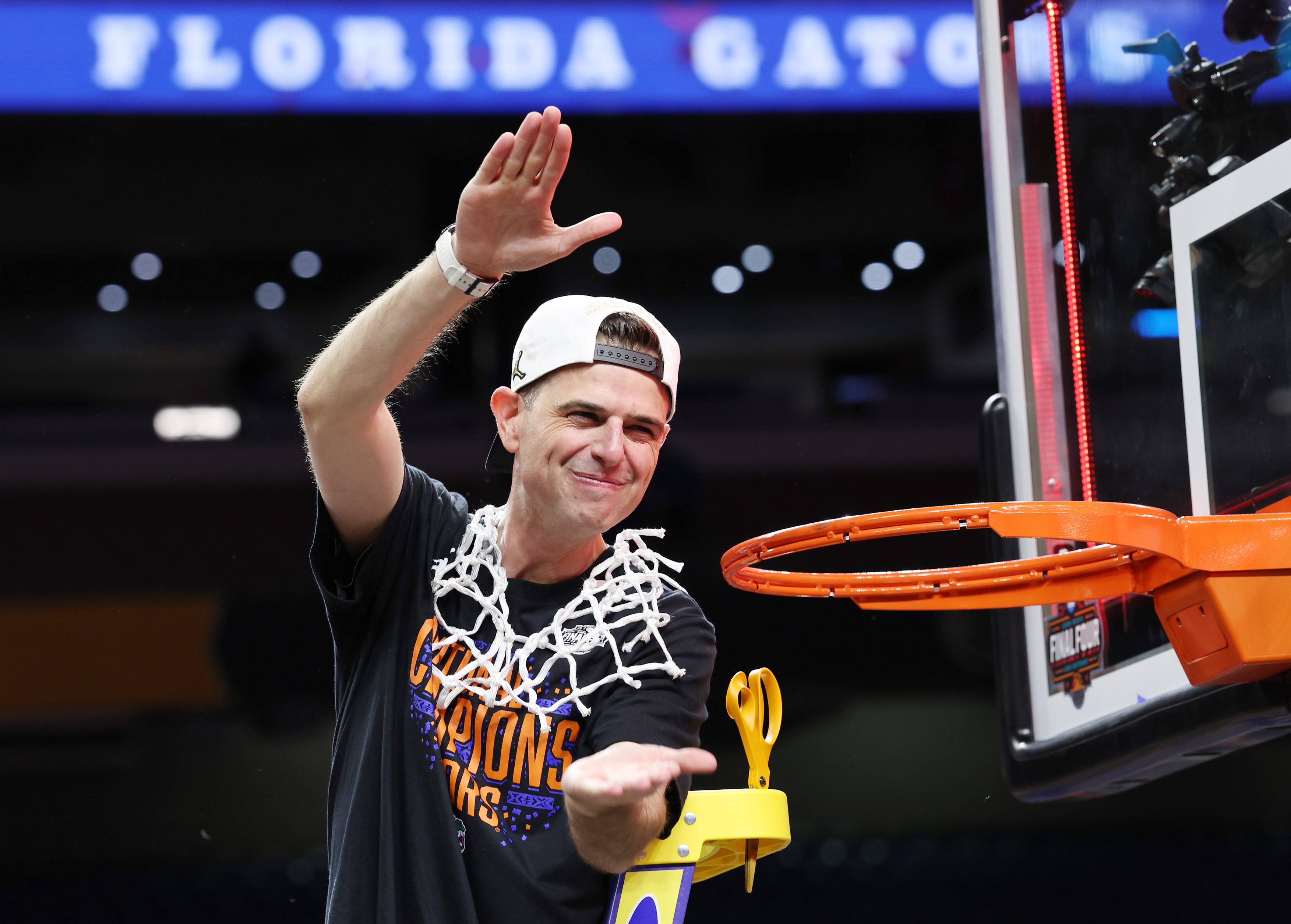 Florida head coach Todd Golden wears the basketball net and celebrates after the Gators beat Houston 65-63 in the Finals of the NCAA Men's Basketball tournament