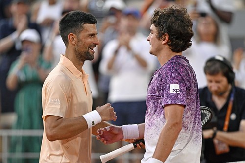 Novak Djokovic of Serbia and Joao Fonseca of Brazil greet each other a