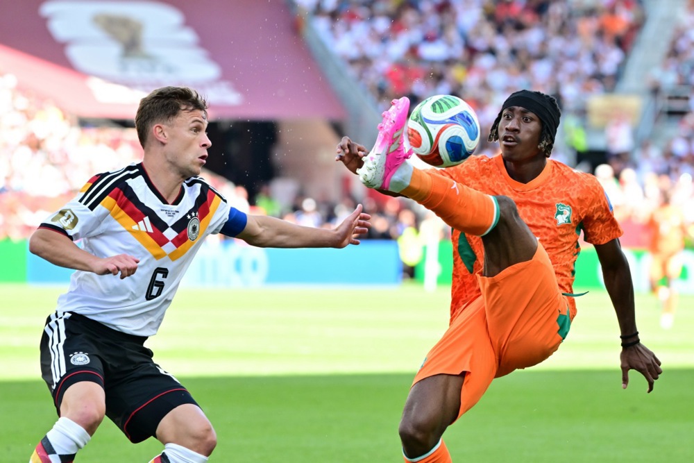 epa13052602 Joshua Kimmich of Germany (L) and Yan Diomande of Ivory Coast (R) in action