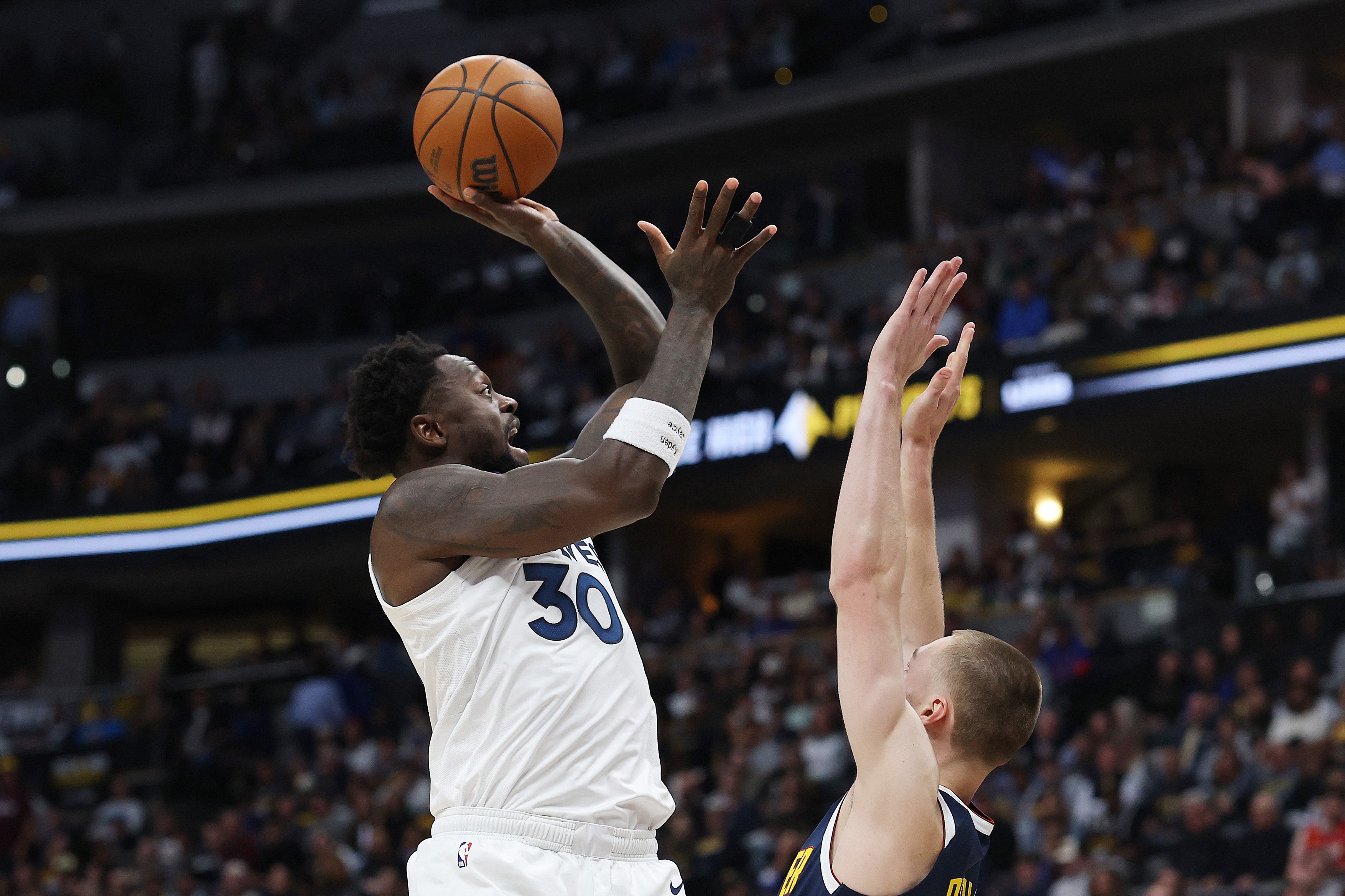 Julius Randle #30 of the Minnesota Timberwolves shoots the ball against Nikola Jokic #15 of the Denver Nuggets