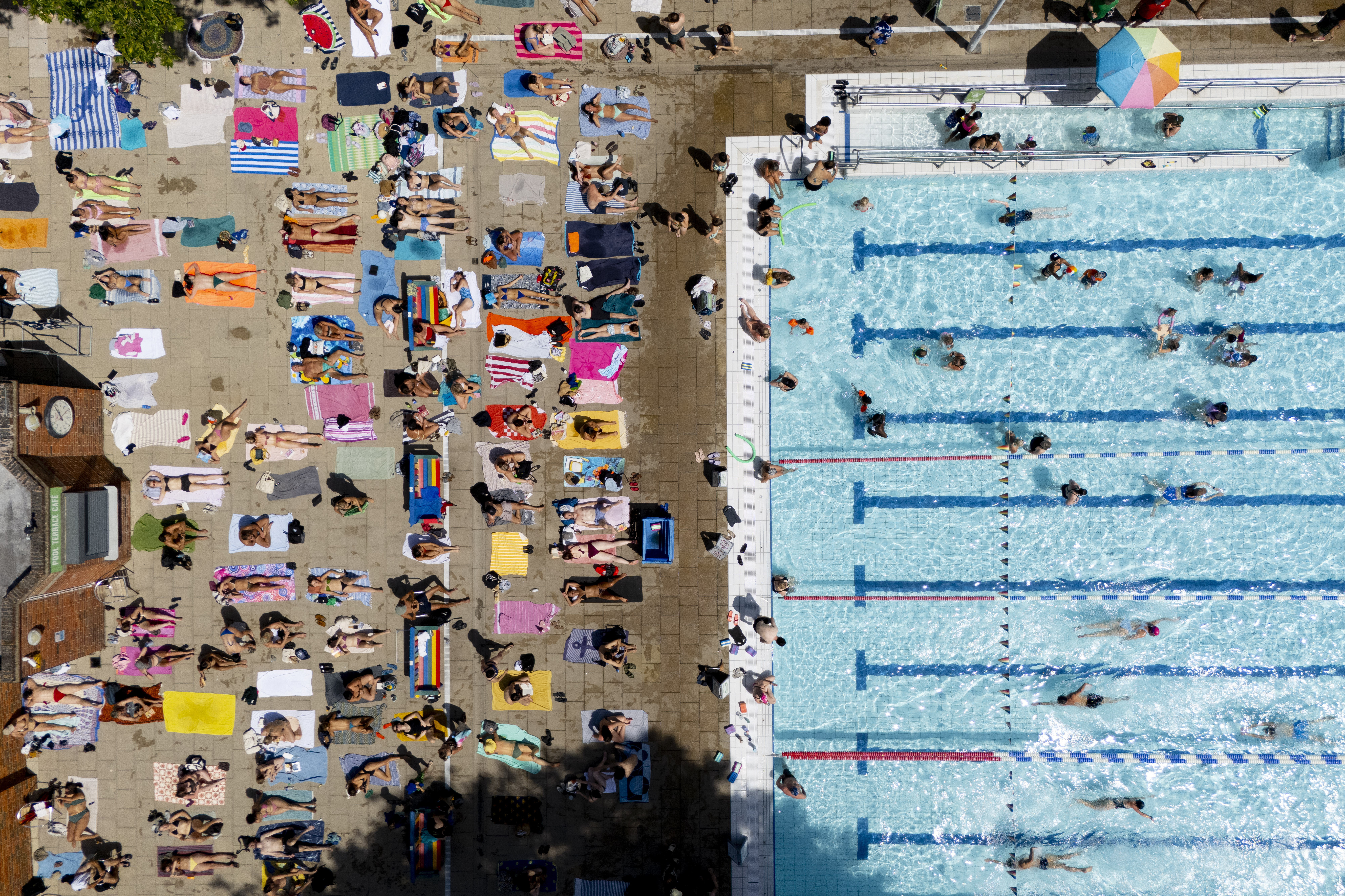 epa13058421 An aerial view taken with a drone shows people sunbathing and swimmi