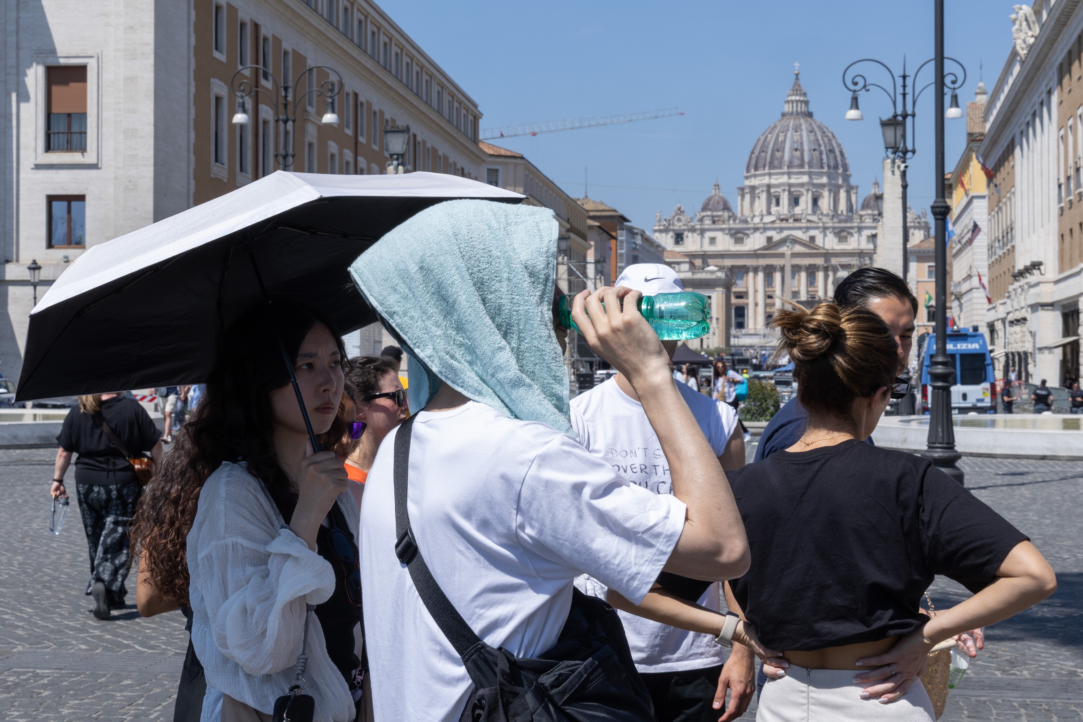 Tourists waiting in line at a water dispenser in Piazza Pia in Rome.Tourists Seek Relie
