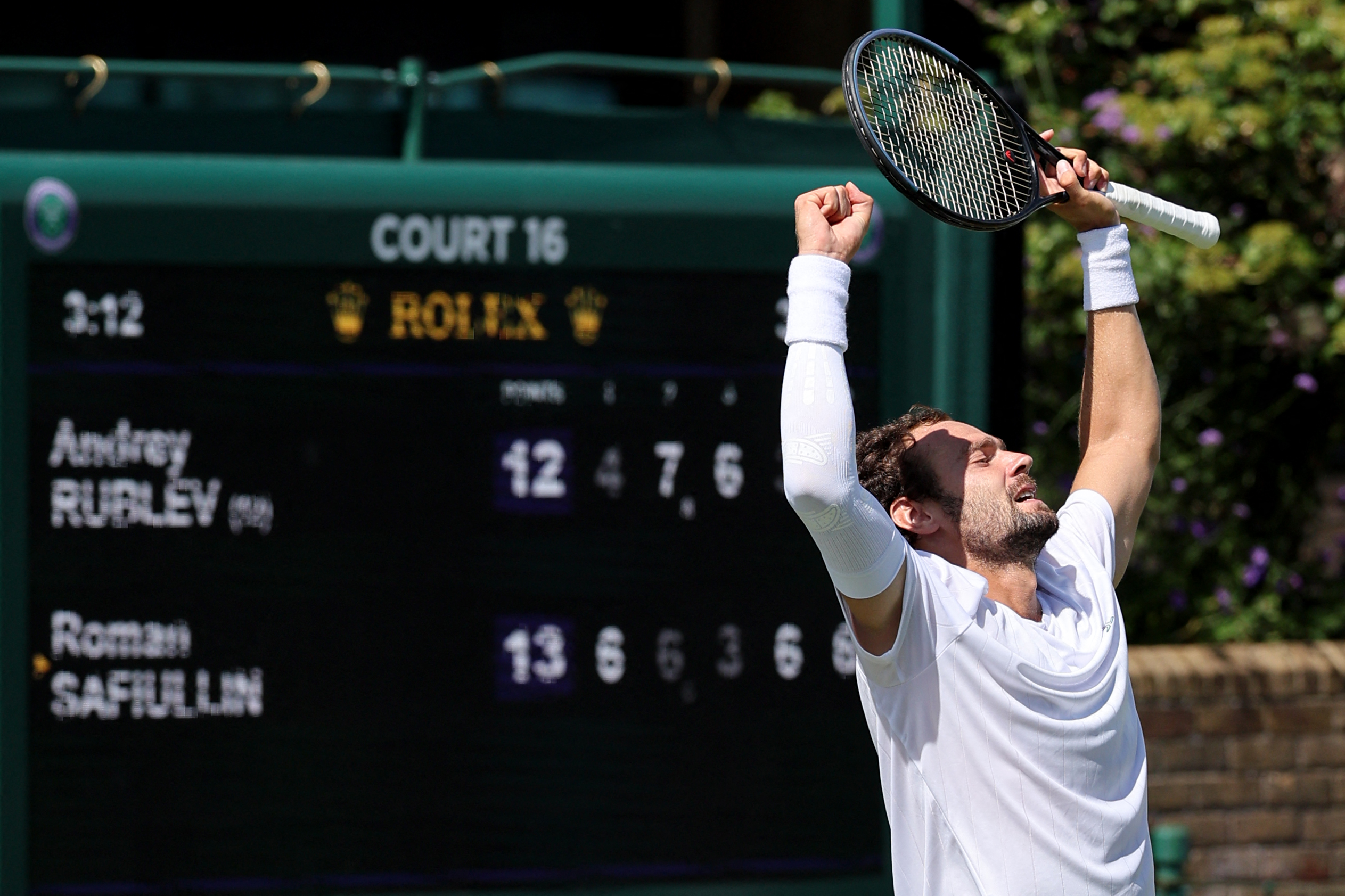 Russia's Roman Safiullin celebrates winning against Russia's Andrey Rublev