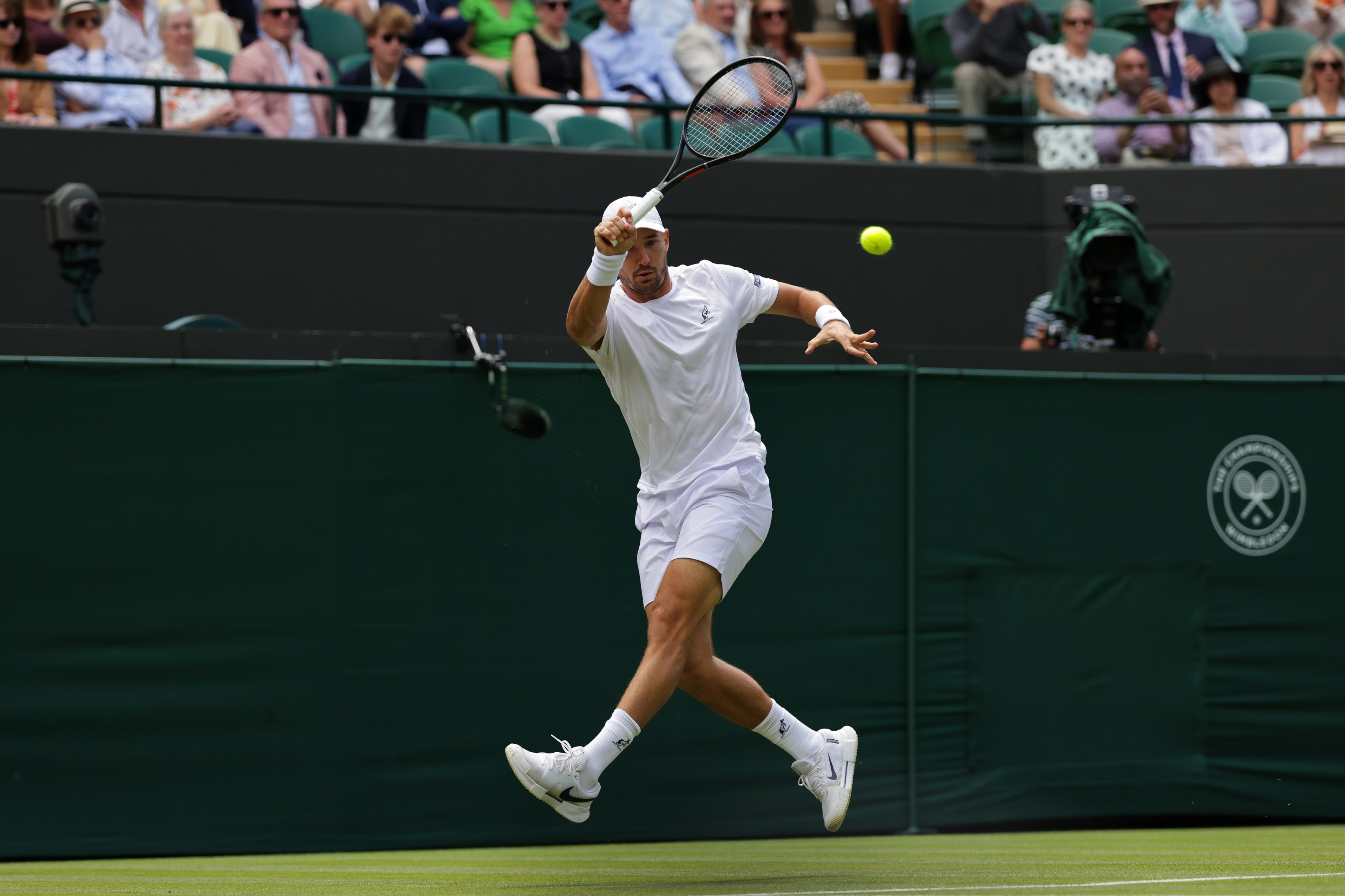 Dusan Lajovic of Serbia returns the ball during the men's singles first round match against Taylor Fritz