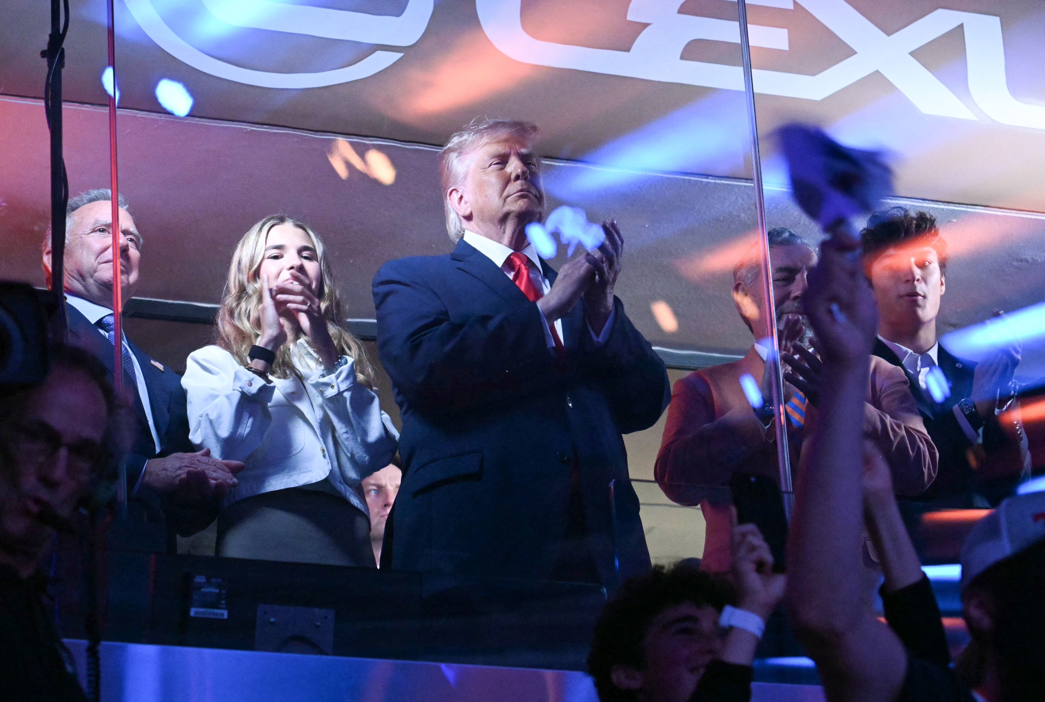US President Donald Trump with his grand daughter Kai Trump (2L) and Knicks owner James Dolan attend Game Three of the NBA Finals between the San Antonio Spurs and the New York Knicks at Madison Square Garden in New York on June 8, 2026.