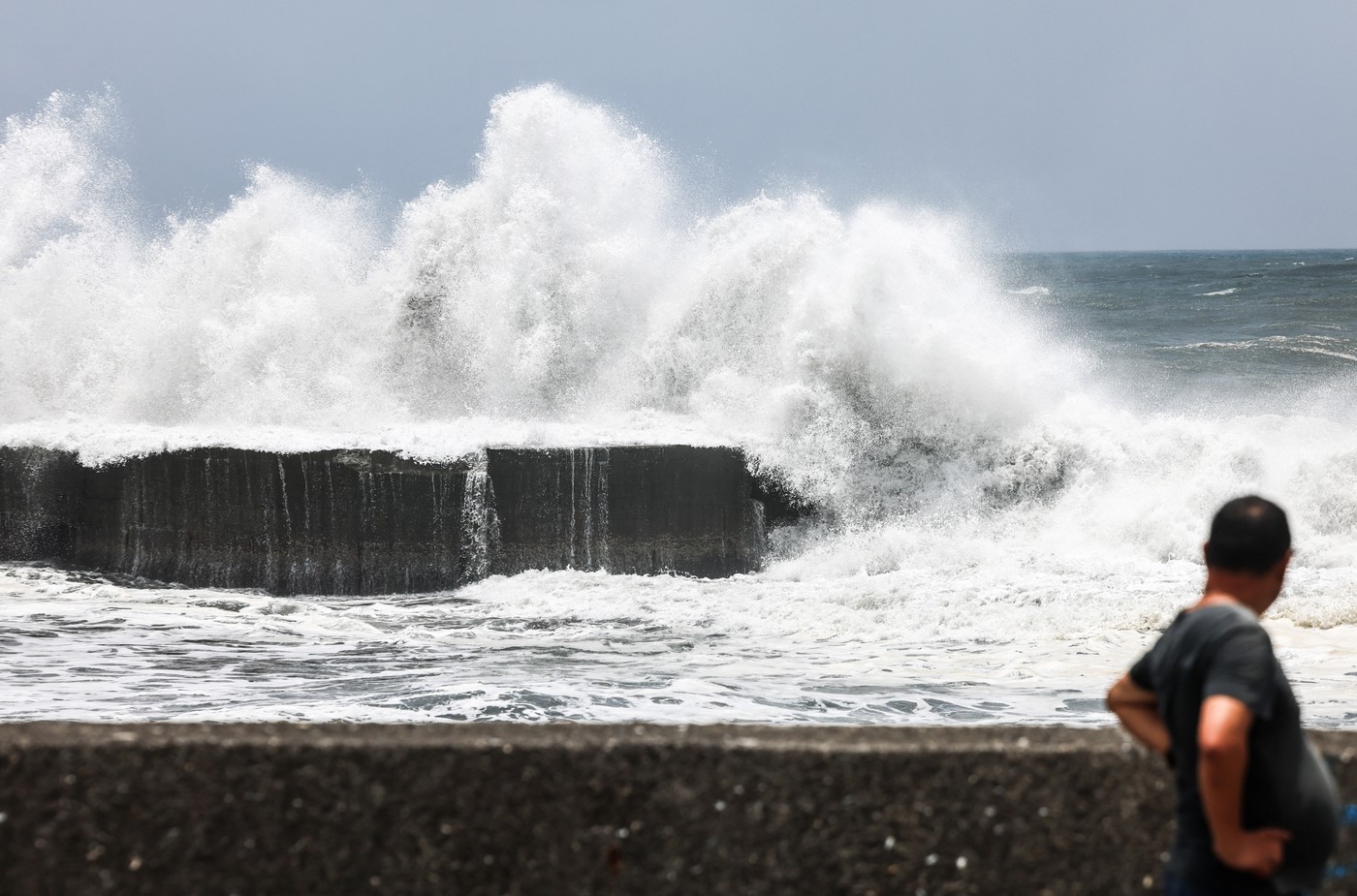 A man looks on as strong waves break along the coast in Yilan on July 10, 2026, as Typhoon Bavi moves toward Northeastern Taiwan.,Image: 1115661954, License: Rights-managed, Restrictions: , Model Release: no  , Credit line: I-Hwa Cheng / AFP / Profimedia