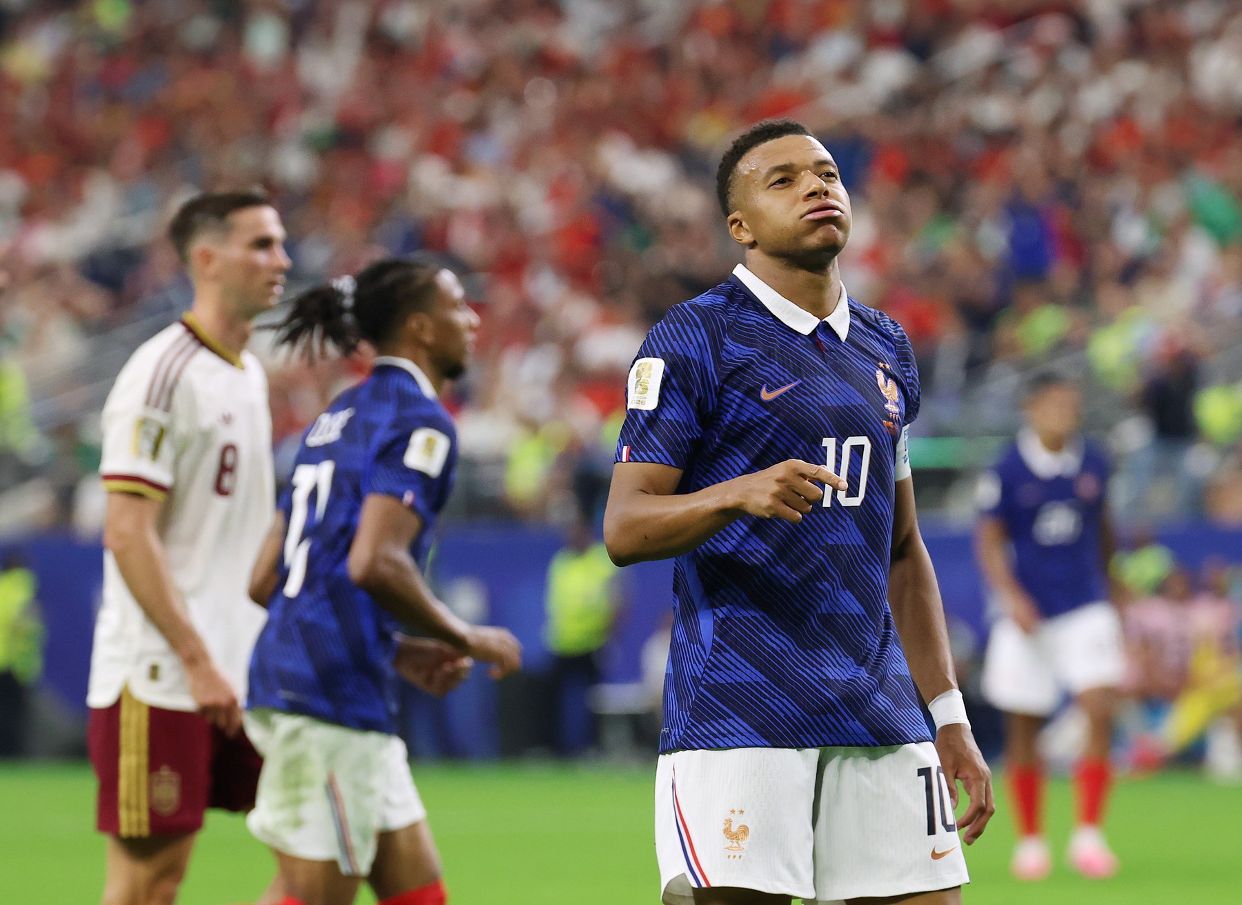 France's Kylian Mbappe, right, reacts after a shot fails to find the net during the