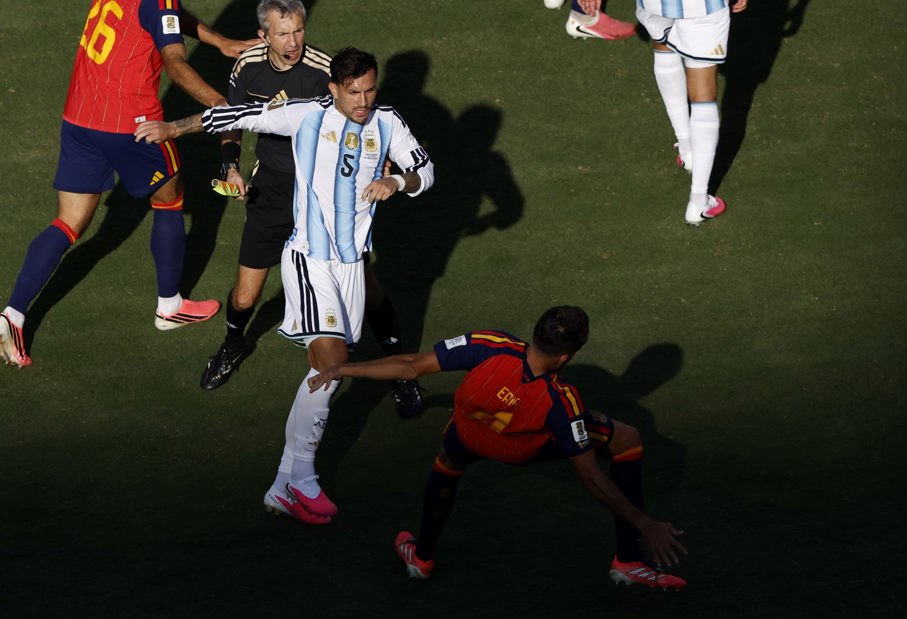 Leandro Paredes of Argentina forces Eric Garcia of Spain to the ground after ti