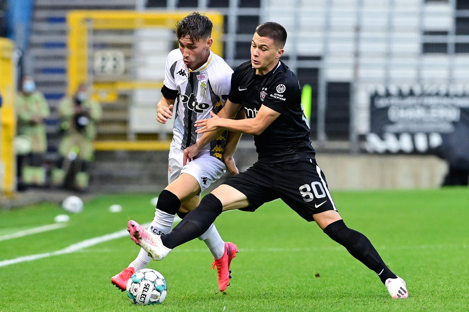Charleroi's Maxime Busi (L) and Partizan's Filip Stevanovic vie for the ball du