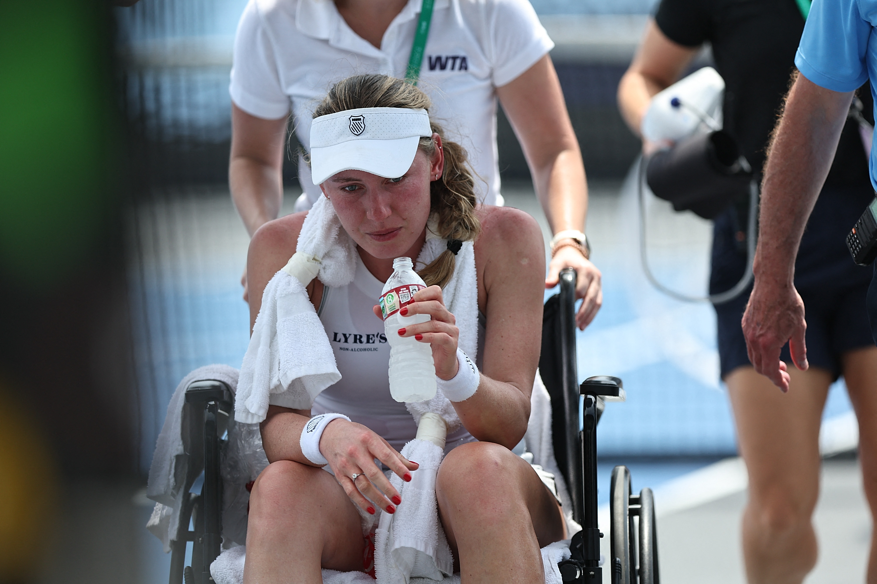 Ekaterina Alexandrova of Russia is escorted off of the court due to a heat related emergency during the match against Kristina Liutova of Russia during the WTA 250 Memphis