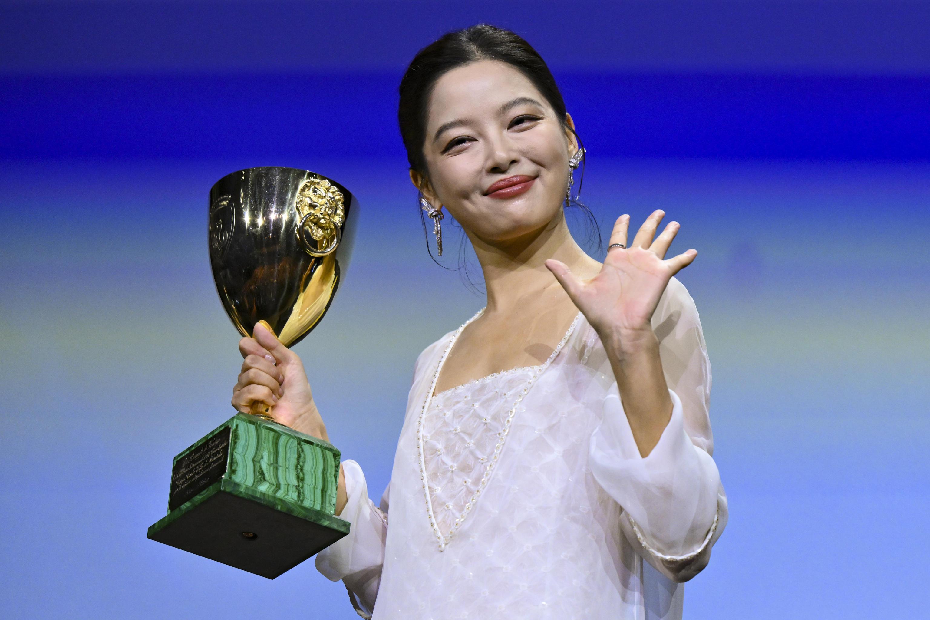 epa12358162 Chinese actor Xin Zhilei poses after receiving the Volpi Cup Award