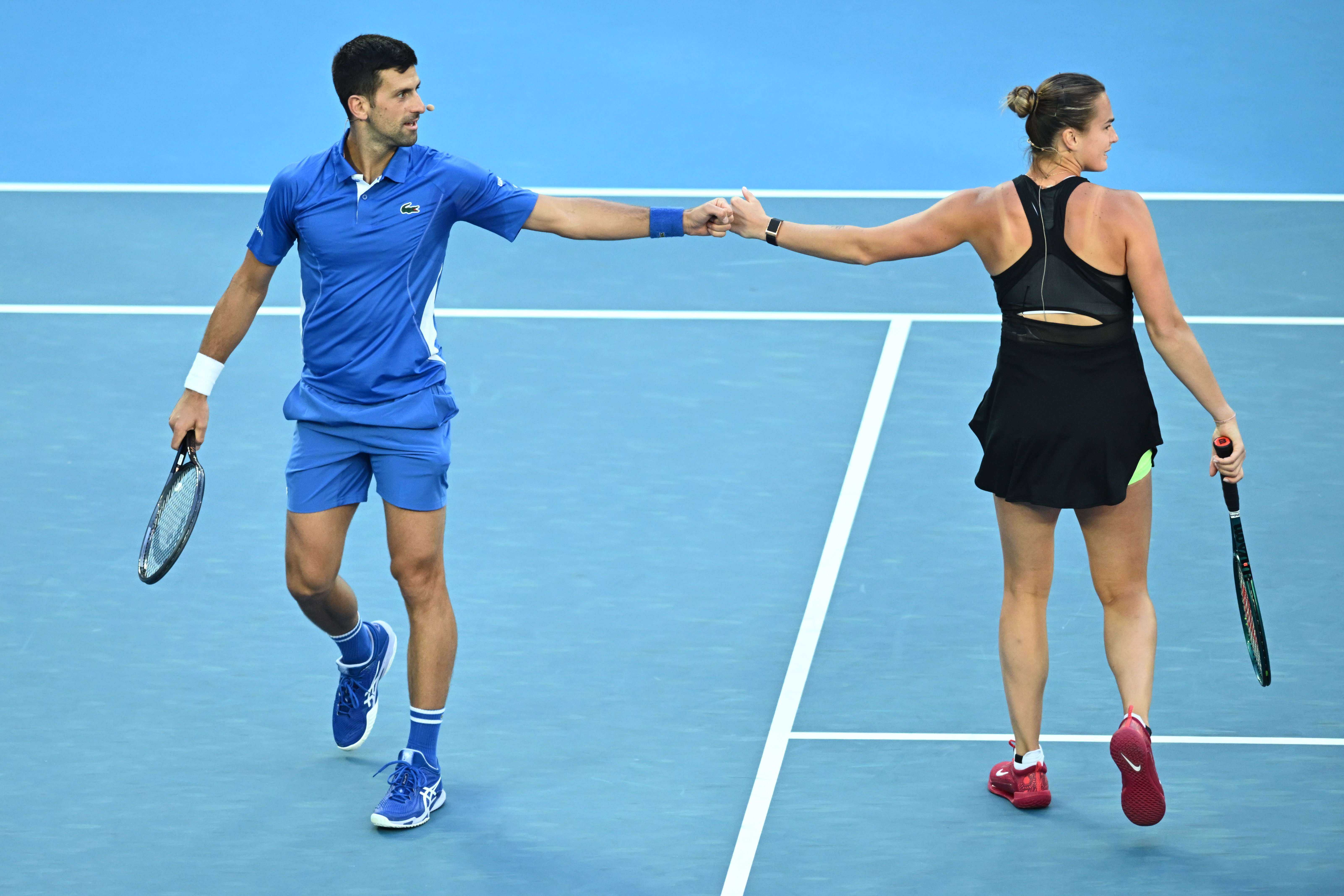 Aryna Sabalenka of Belarus (right) and Novak Djokovic of Serbia in action