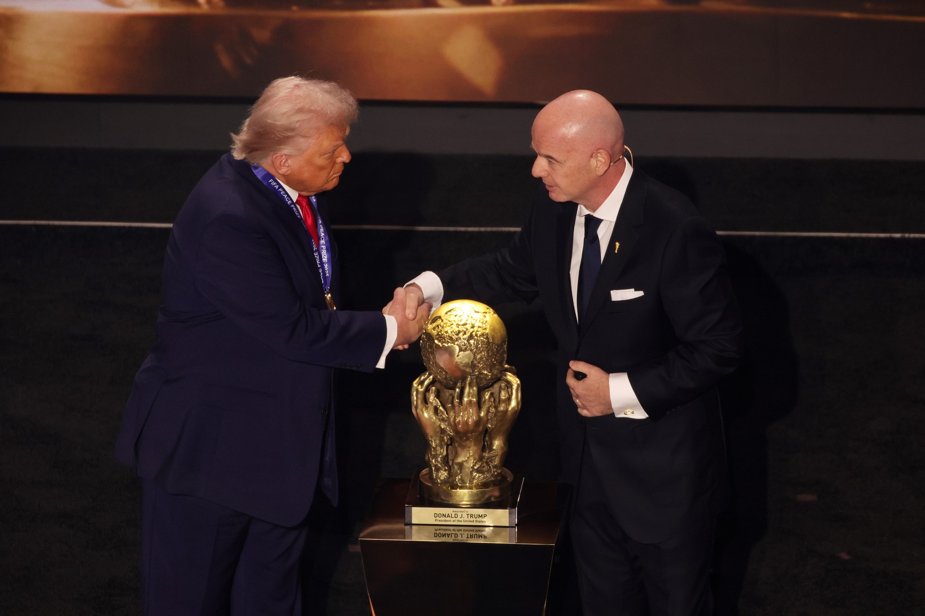 File photo dated 05-12-2025 of US President Donald Trump is presented with th