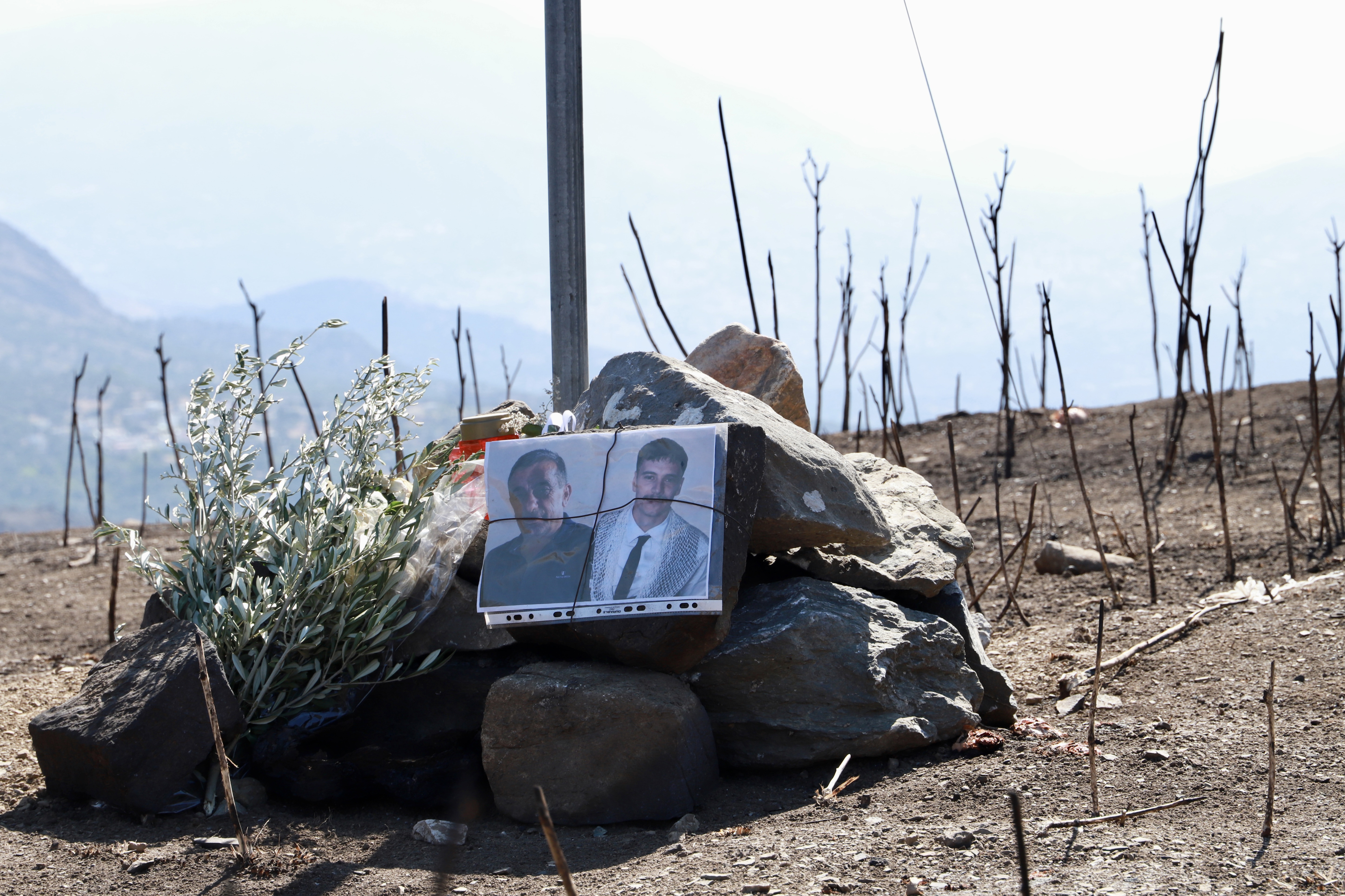 epa13145157 Photographs depict two firefighters who died while battling a wildf