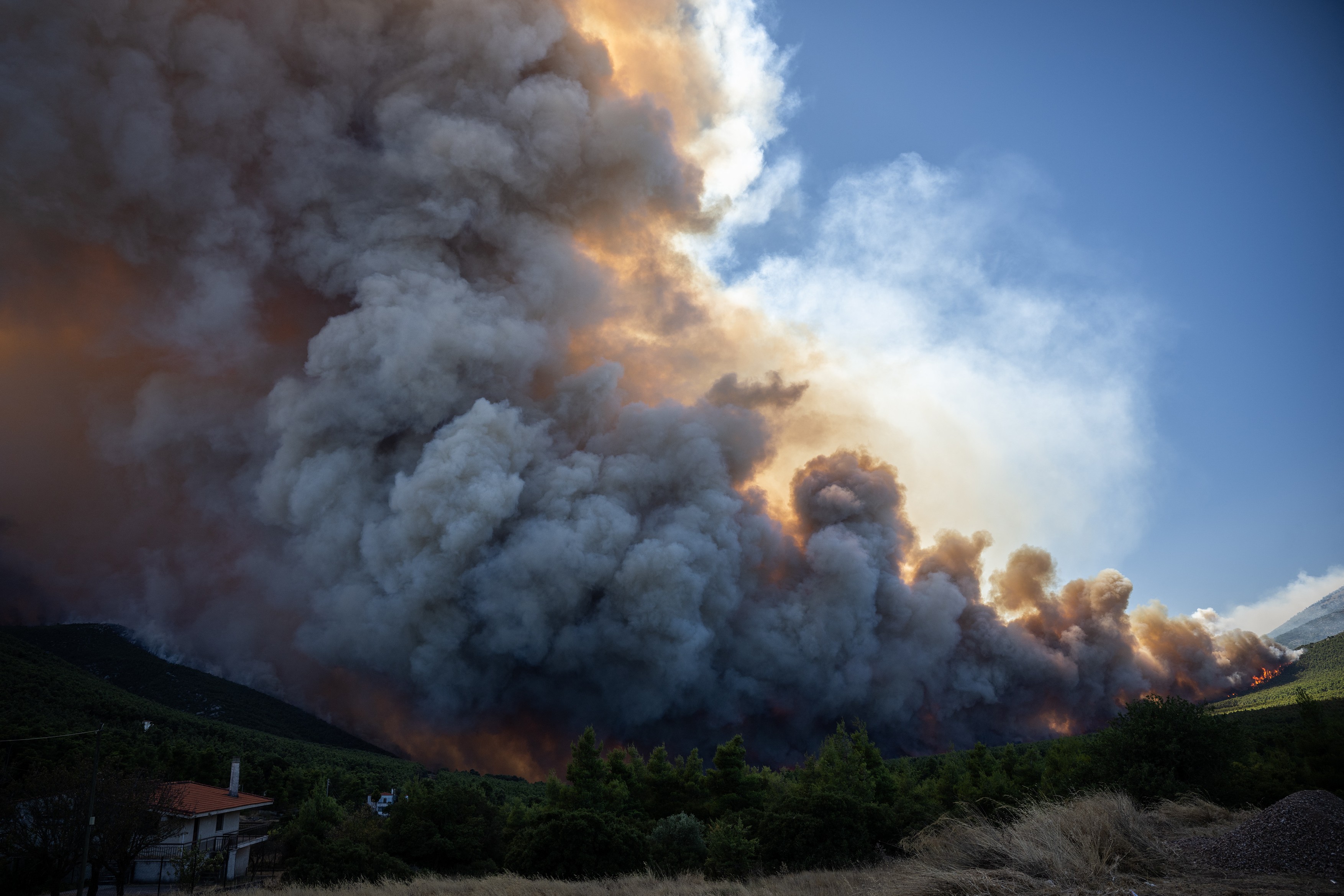 Heavy smoke rises from a wildfire in the area of Porto Germeno,