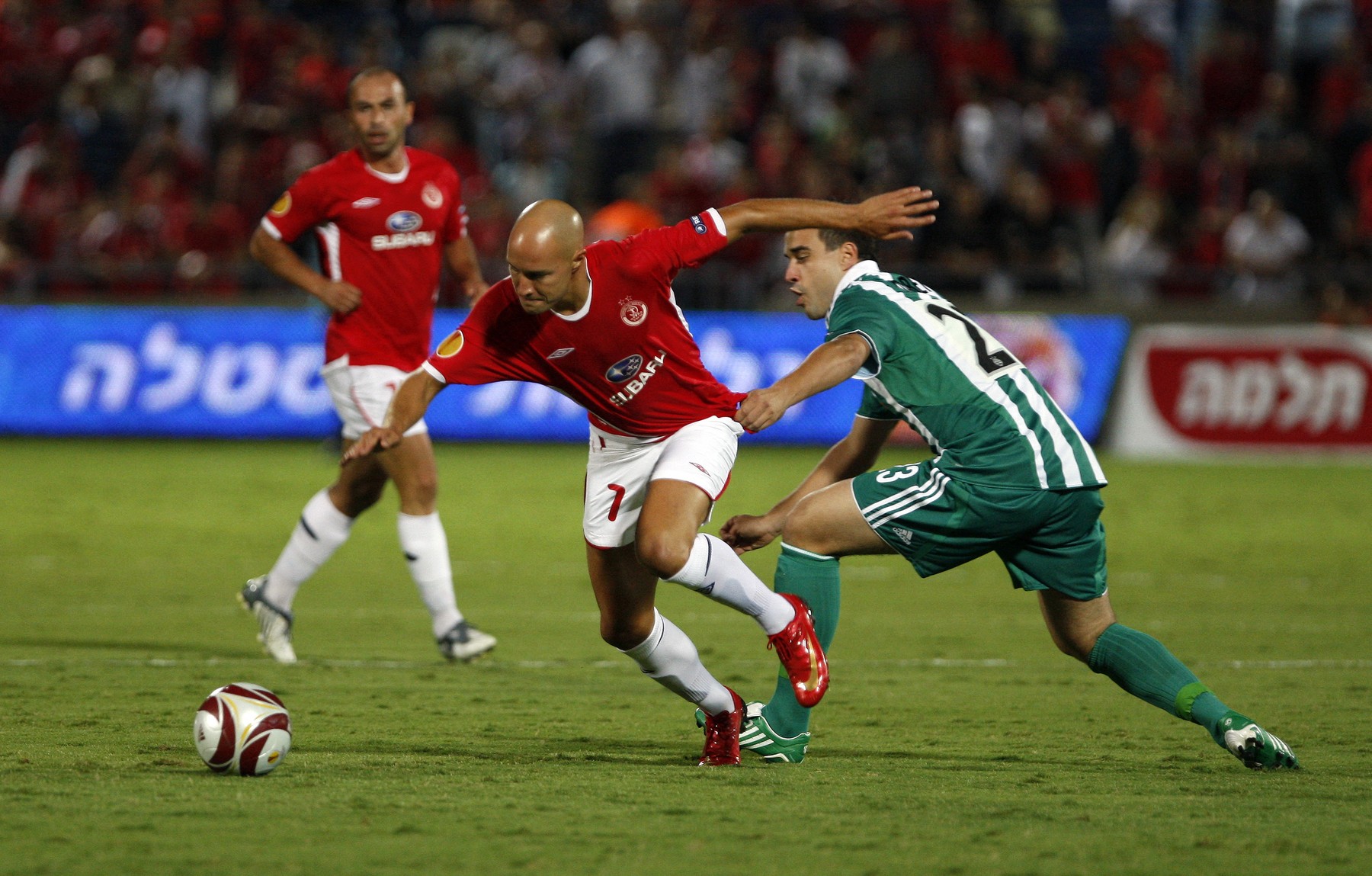 Rapid Vienna's defender Andreas Dober (R) battles for the all with Hapoel Tel