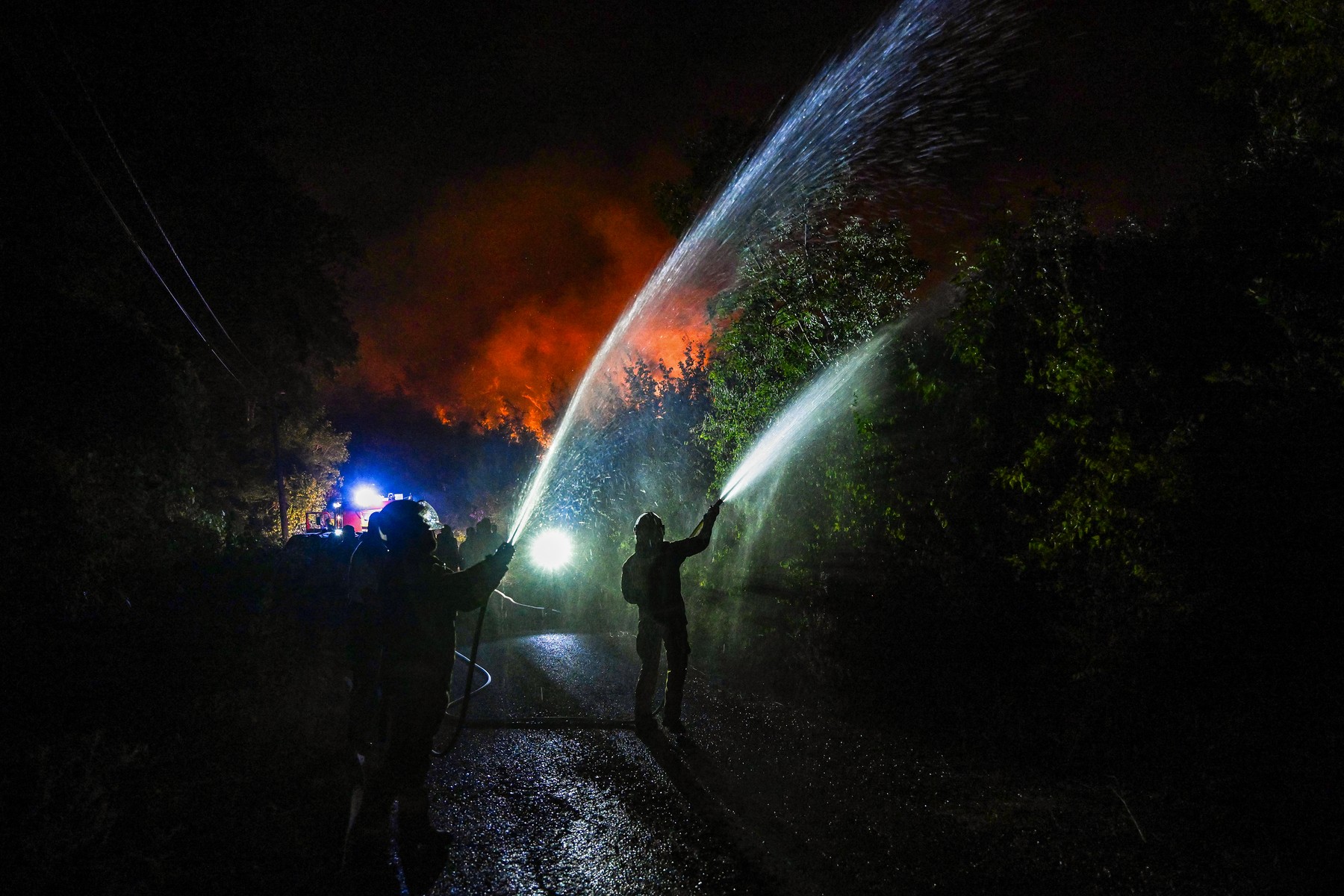 Firefighters battle a wildfire near the village of Zogaj, outside the coastal town of Ulcinj, Montenegro, on August 13, 2026.,Image: 1122803499, License: Rights-managed, Restrictions: , Model Release: no  , Credit line: SAVO PRELEVIC / AFP / Profimedia
