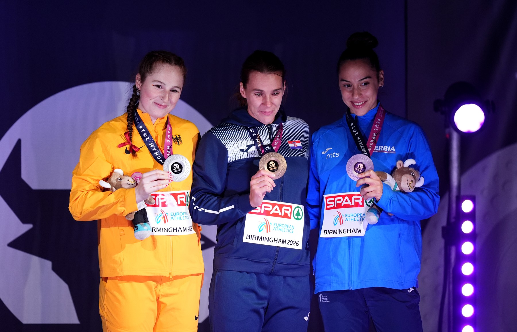 Gold medalist Sara Kolak of Croatia (centre) alongside silver medalist Julia Ulb