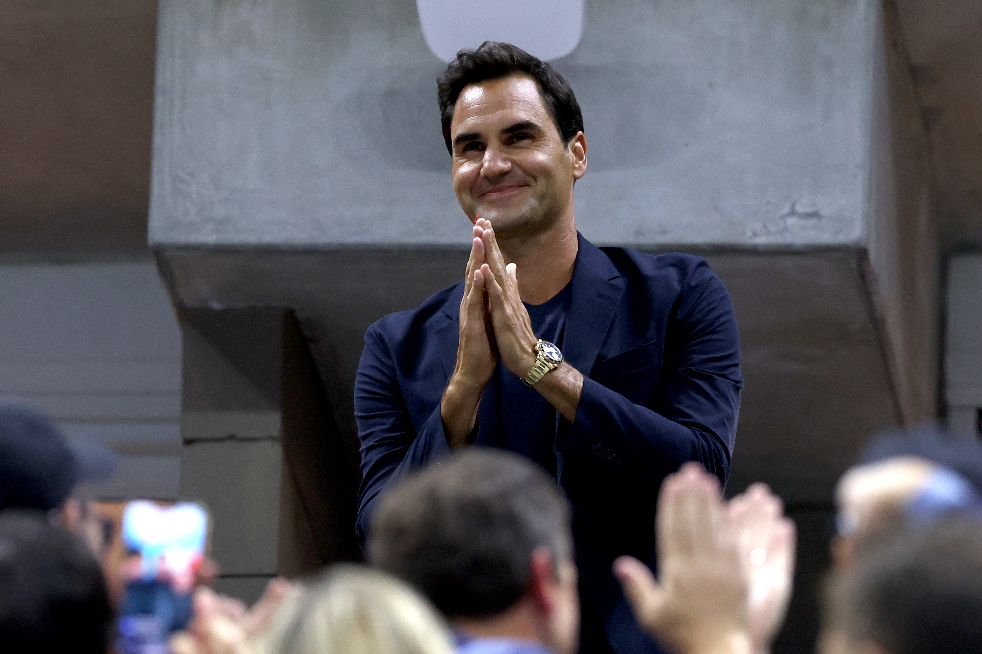 Roger Federer is recognized during the Women's Singles Quarterfinal match between Zheng Qinwen of China and Aryna Sabalenka of Belarus
