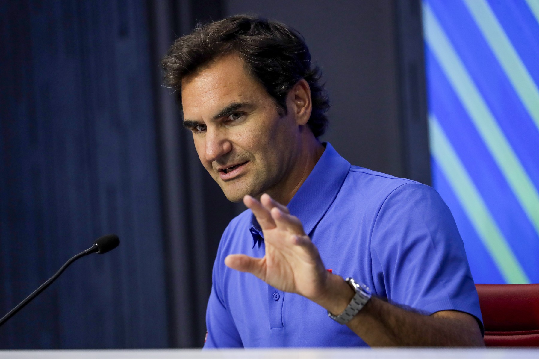 Roger Federer speaks to the media during a press conference inside Arthur As