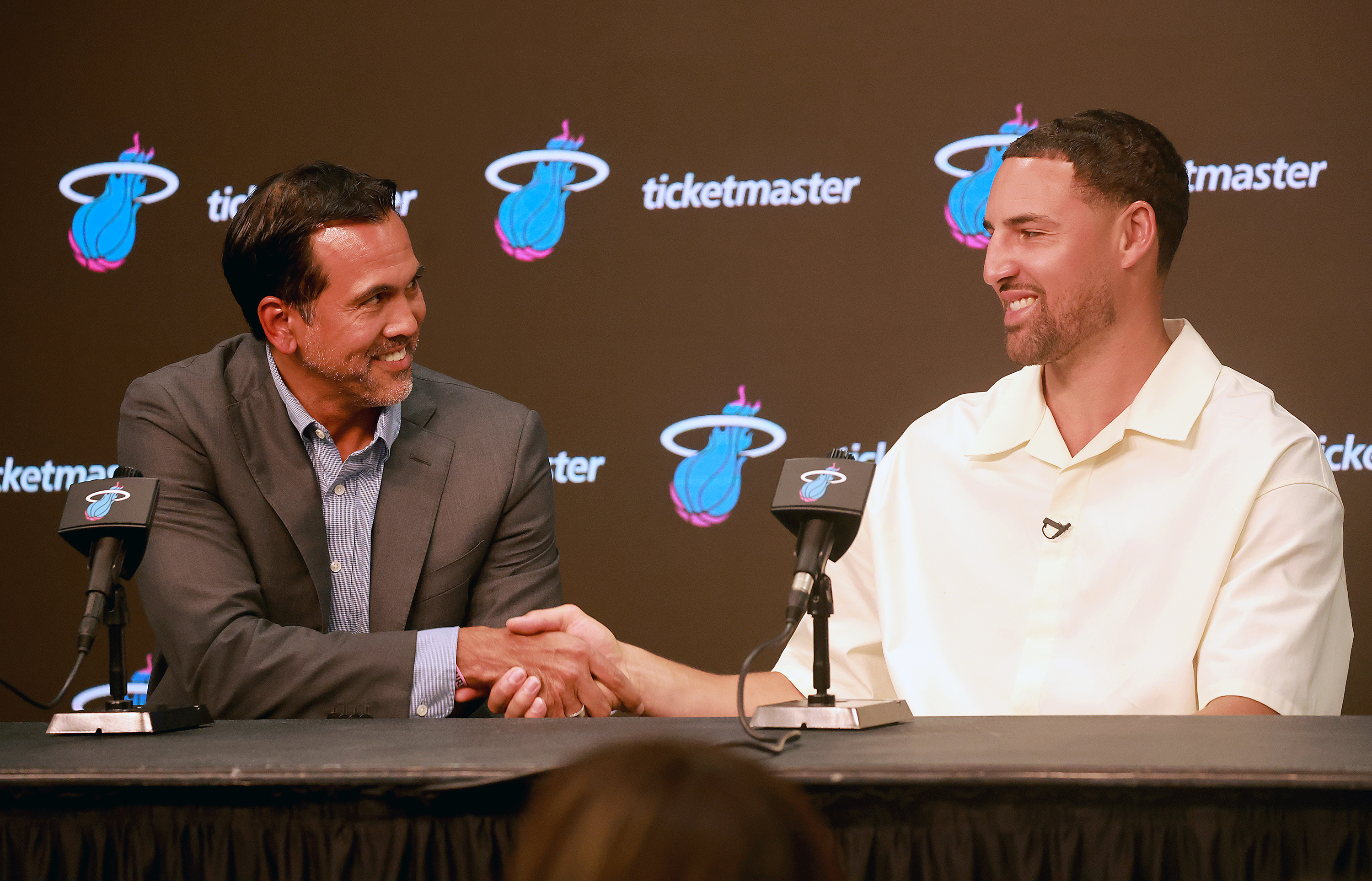 Miami Heat head coach Erik Spoelstra, left, shakes hands with guard Klay Thompson