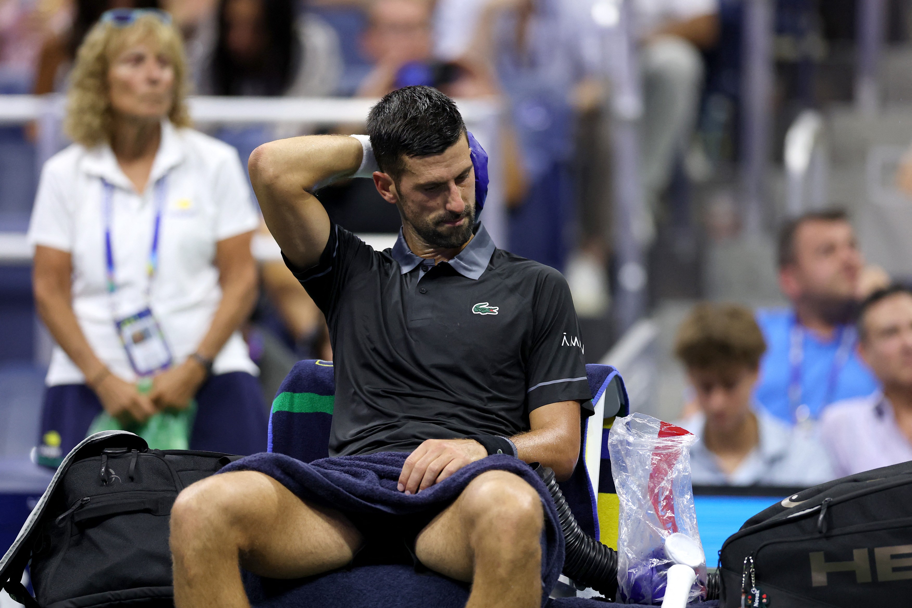 NEW YORK NEW YORK - AUGUST 30: Novak Djokovic of Serbia cools off on the bench