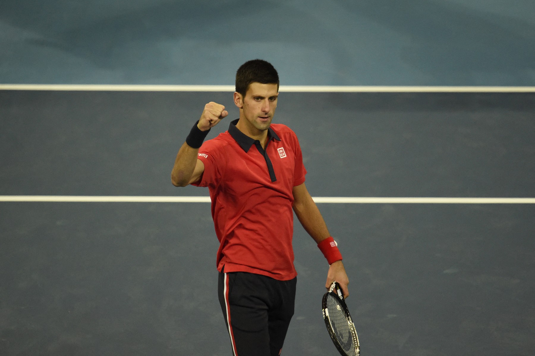 Novak Djokovic of Serbia celebrates winning against John Isner of the