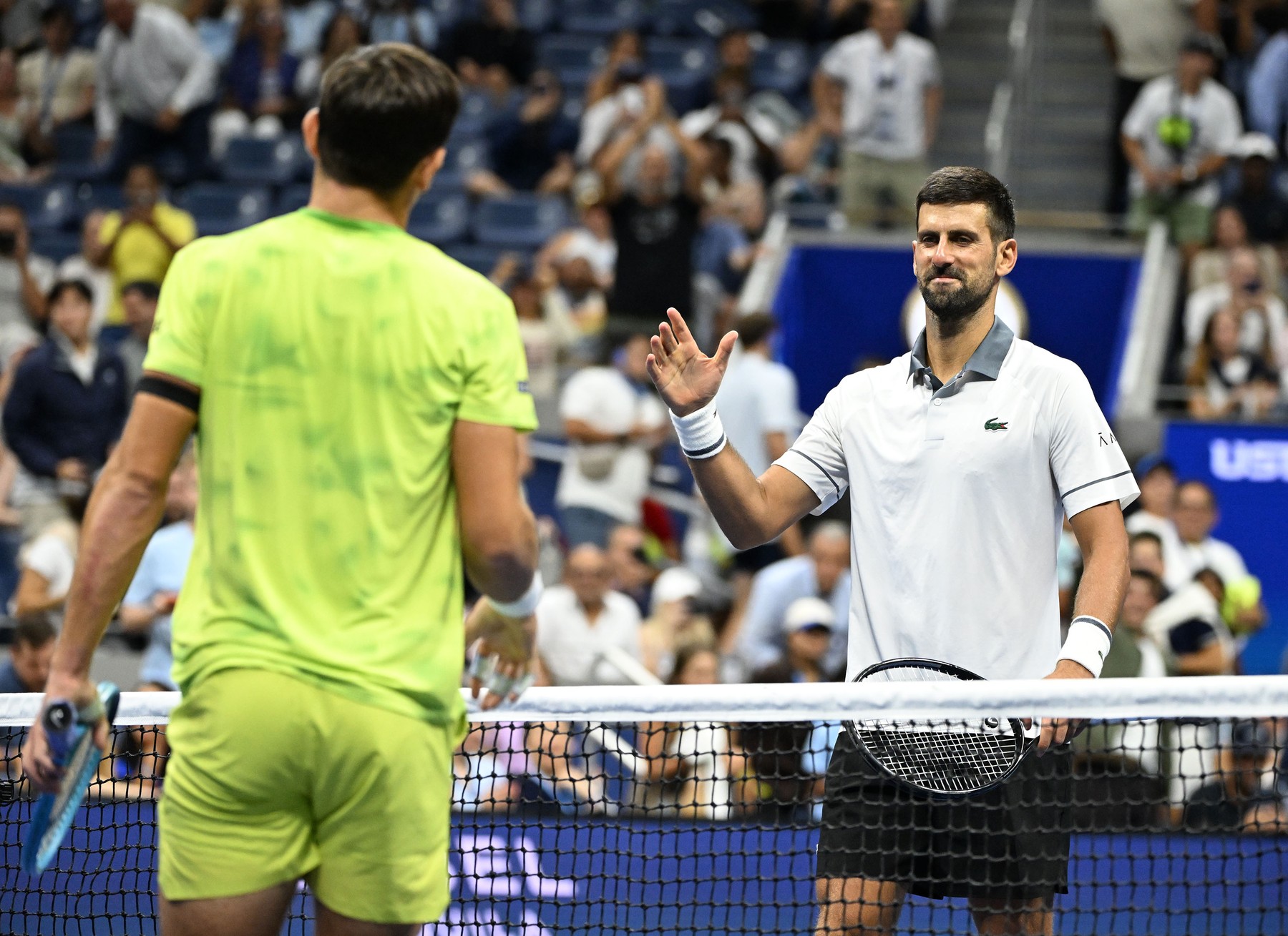 FLUSHING NY- AUGUST 30: Novak Djokovic greats  Mariano Navone at the net a