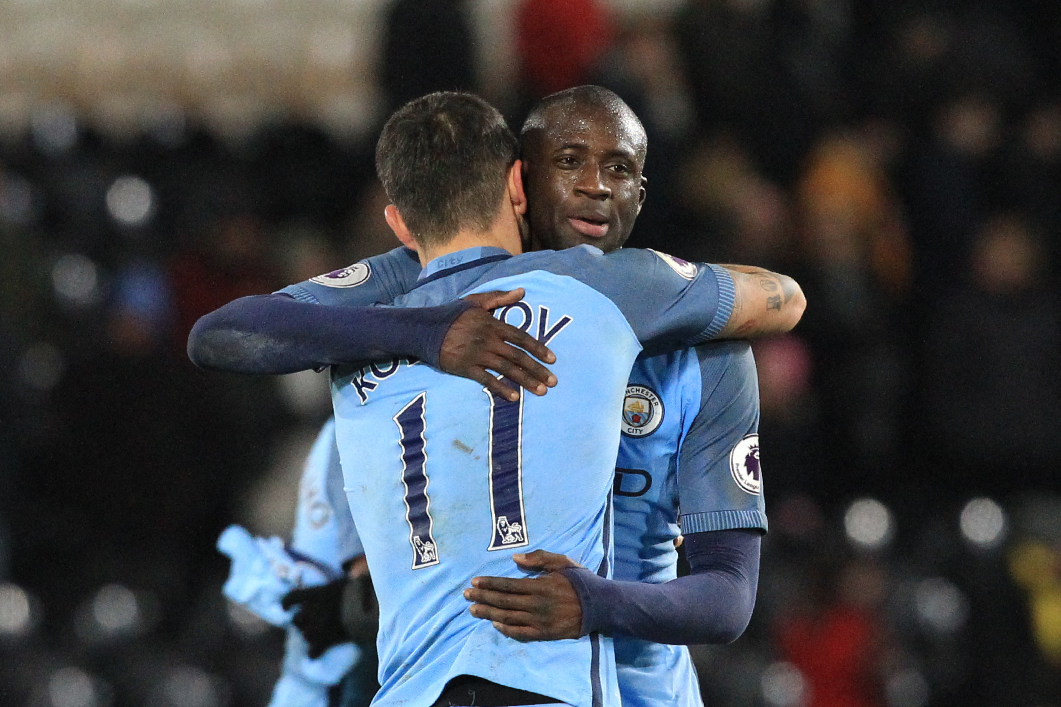 Manchester City's Ivorian midfielder Yaya Toure (R) embraces Manchester City's Serbian defender Aleksandar Kolarov (L)