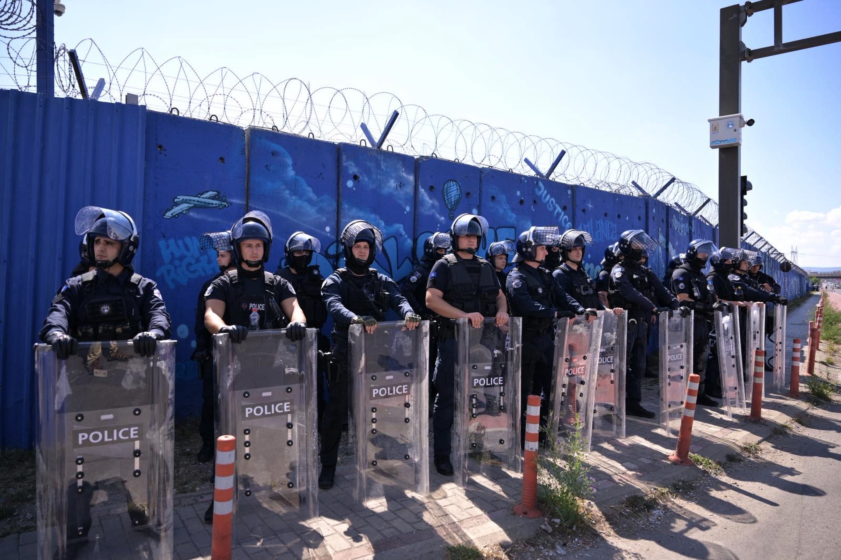 epa13243535 Riot police officers stand guard in front of t